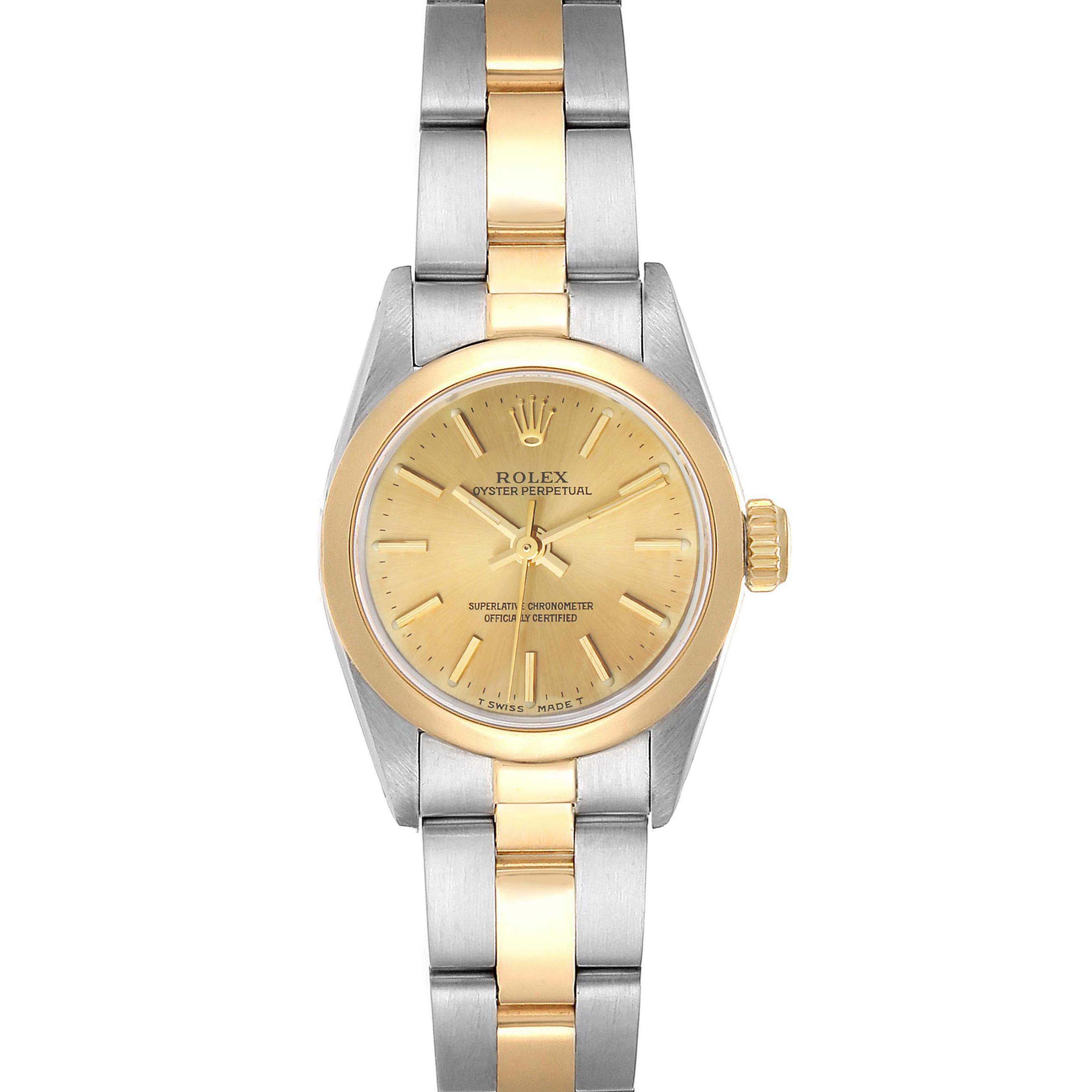 The image shows a front view of a Rolex Oyster Perpetual 67183 Women's Steel and Gold (two tone) Champagne Dial 67183 Women's Steel and Gold (two tone) Champagne Dial watch with a gold and steel band and a gold dial.