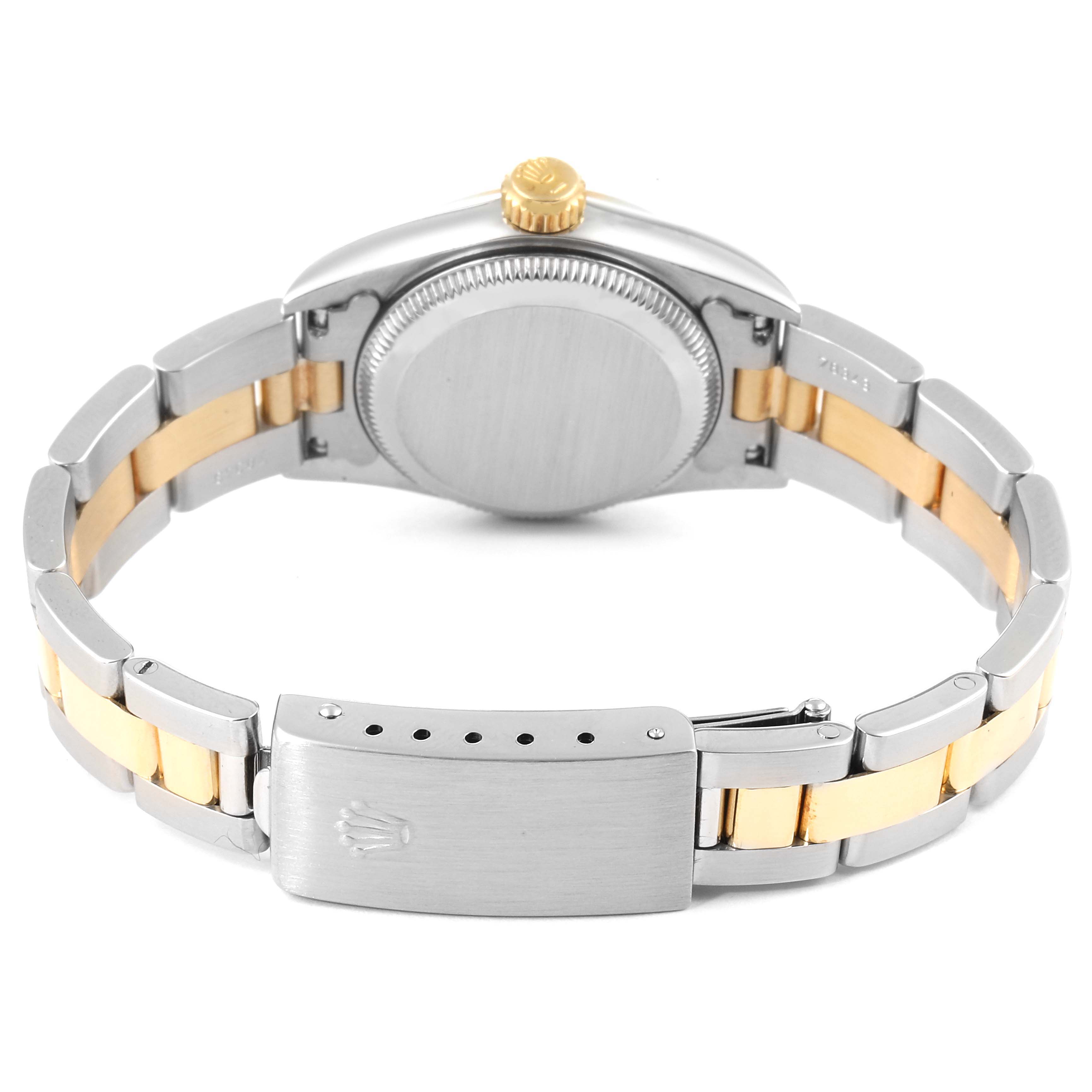 This image shows the Rolex Oyster Perpetual 67183 Women's Steel and Gold (two tone) Champagne Dial 67183 Women's Steel and Gold (two tone) Champagne Dial watch from the back, featuring the case back, crown, and bi-metal bracelet with the clasp closed.