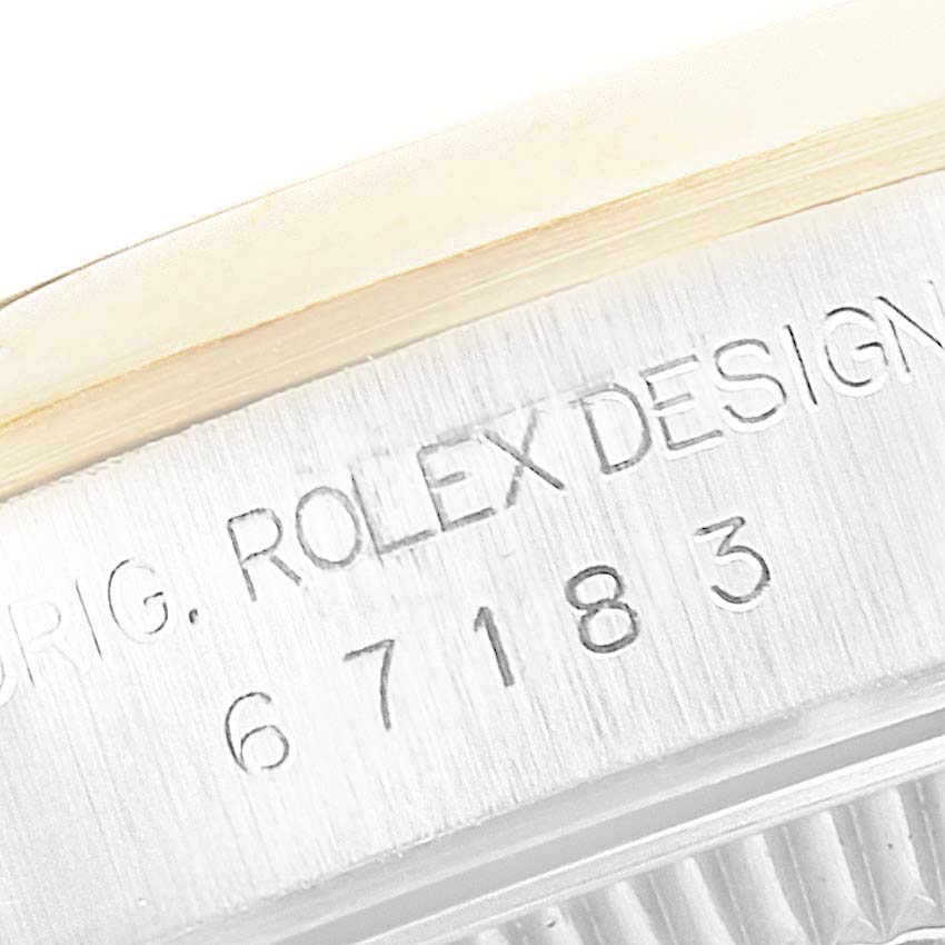 This close-up image shows the engraved serial number on the side of a Rolex Oyster Perpetual 67183 Women's Steel and Gold (two tone) Champagne Dial 67183 Women's Steel and Gold (two tone) Champagne Dial watch.