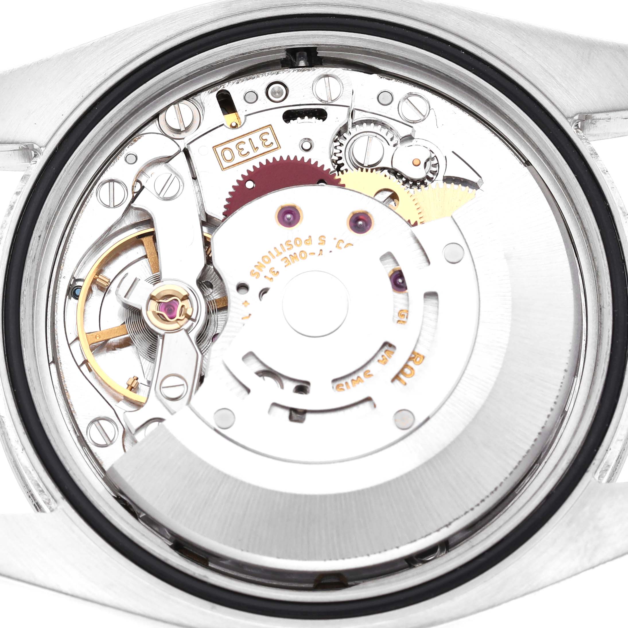 The image shows the back view of a Rolex Oyster Perpetual 116034 Men's Stainless Steel Black Dial, highlighting the intricate movement and gears.