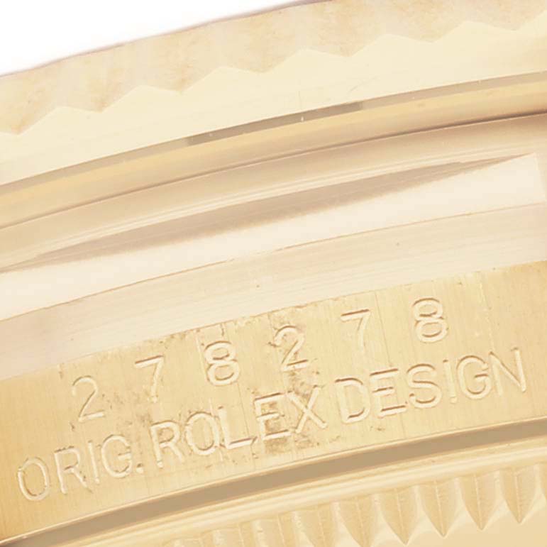 The image shows a close-up of the Rolex President 278278 Women
s Yellow Gold Champagne Dial 278278 Women
s Yellow Gold Champagne Dial watch
s bezel and case side, highlighting its engraved design numbers.