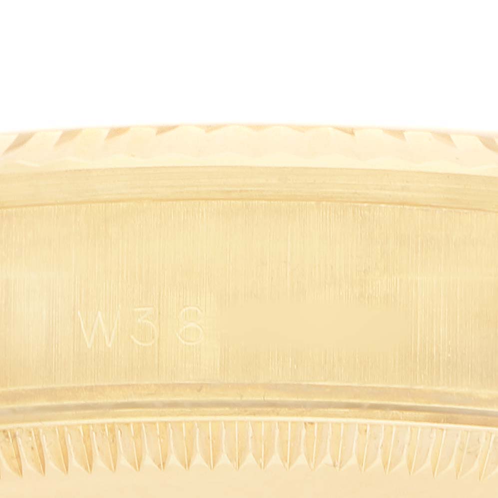 The image shows a close-up of the side of a Rolex President 68278 Women's Yellow Gold White Dial model watch, highlighting the serial number area and fluted bezel.