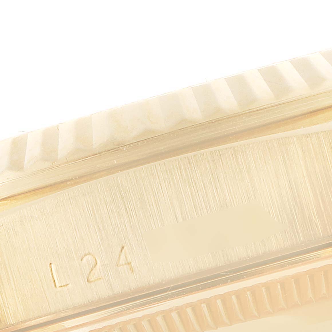 This image shows a close-up of the bezel and part of the side case of a Rolex President 18238 Men's Yellow Gold Champagne Dial 18238 Men's Yellow Gold Champagne Dial model.