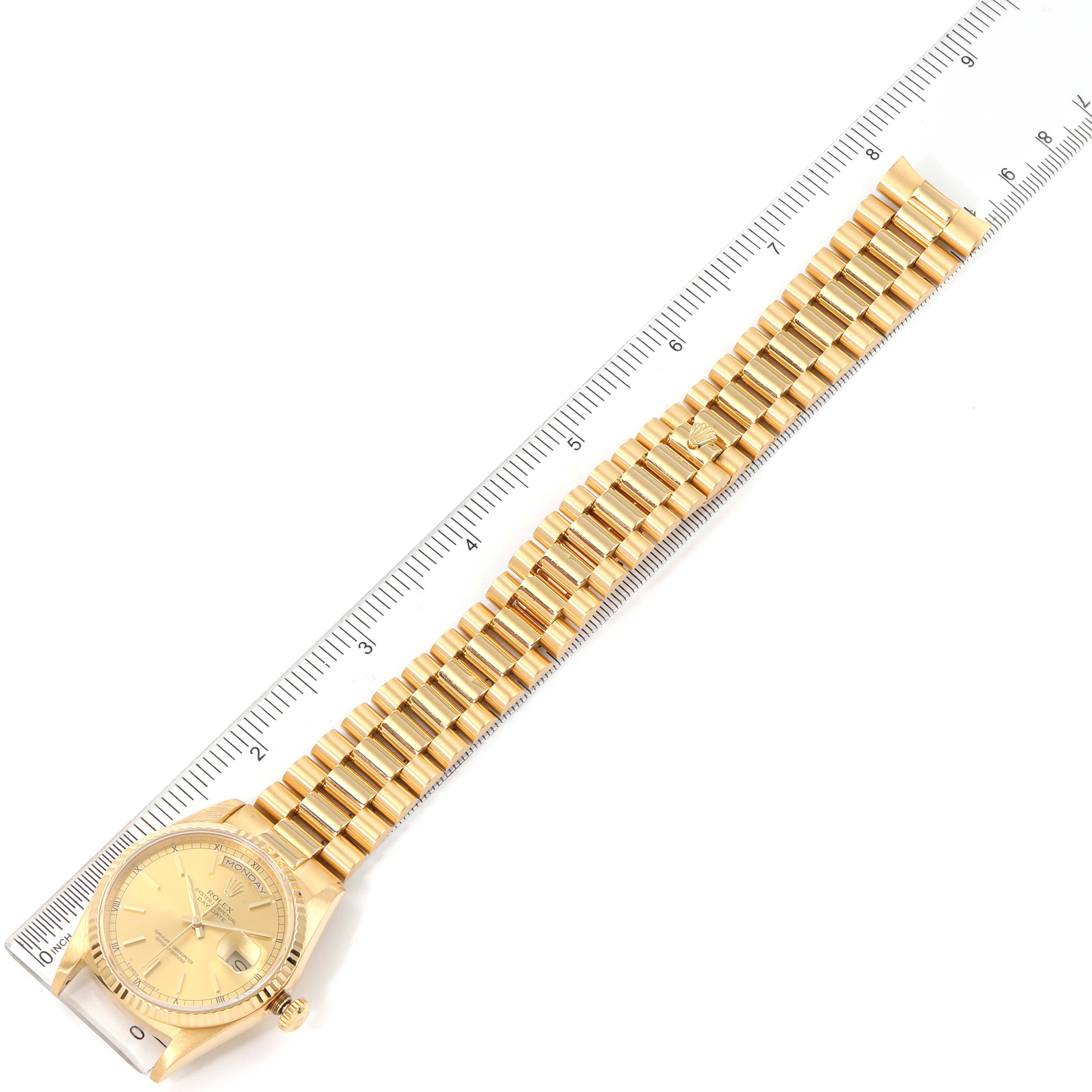 The image shows a Rolex President 18238 Men's Yellow Gold Champagne Dial 18238 Men's Yellow Gold Champagne Dial model watch laid flat with a ruler beside it, showcasing the face and a full view of the bracelet.