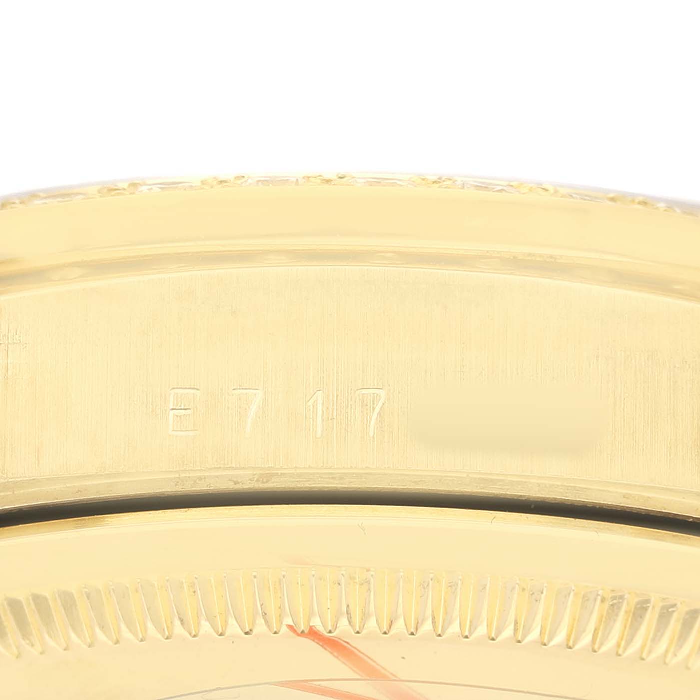 The image shows the side view of a Rolex President 18348 Men's Yellow Gold Champagne Dial watch, focusing on the engraved serial or model numbers on the case.