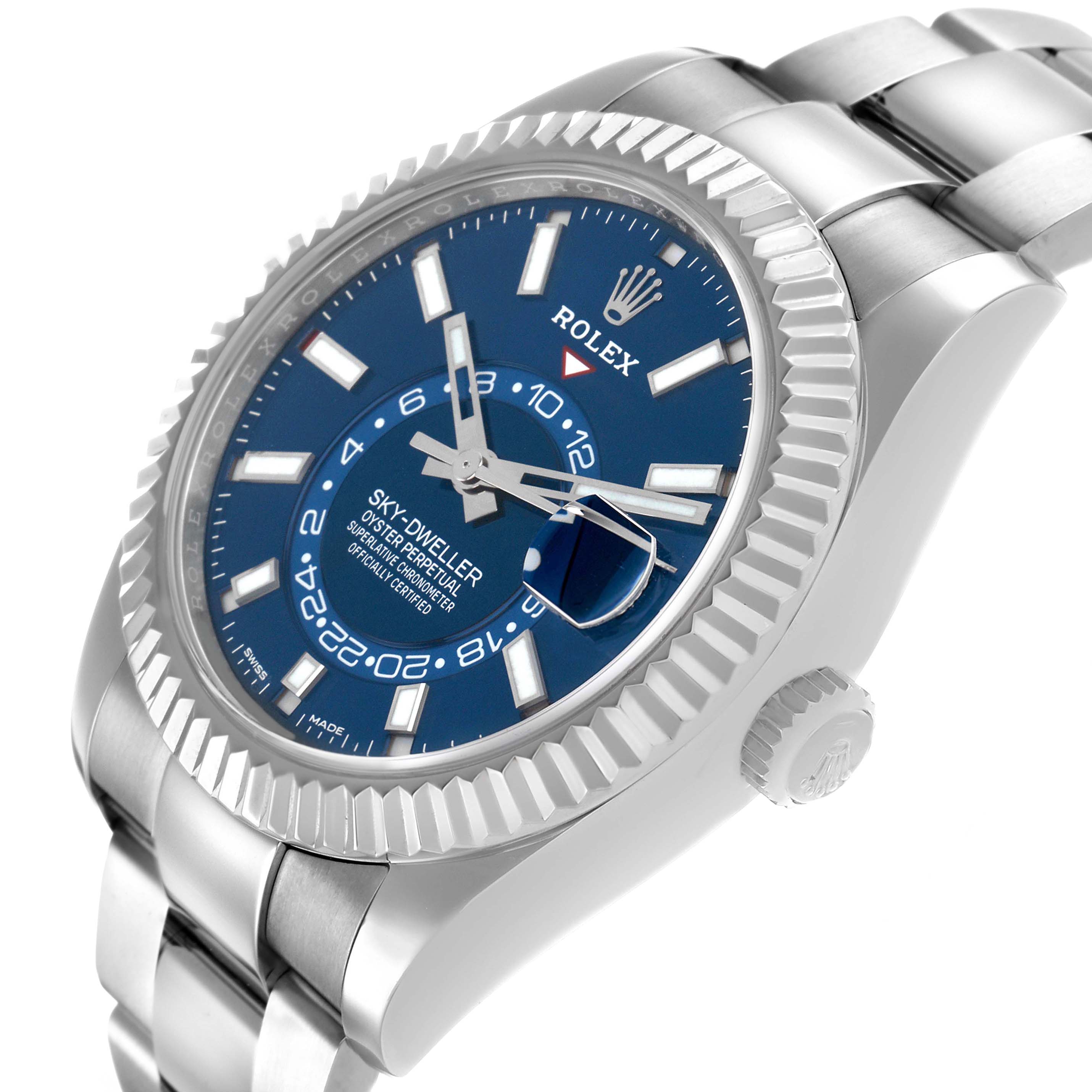 The Rolex Sky-Dweller 326934 Men's Stainless Steel Blue Dial watch is shown at a tilted front angle, displaying the face, fluted bezel, crown, and part of the bracelet.
