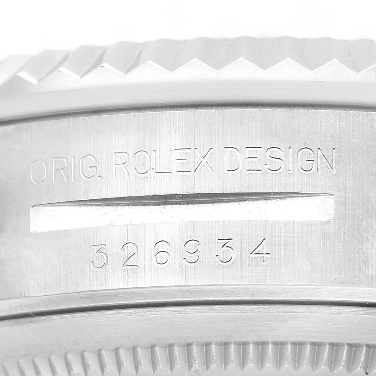 The image shows a close-up of the engraved edge of a Rolex Sky-Dweller 326934 Men's Stainless Steel Blue Dial, highlighting the serial number and design details.