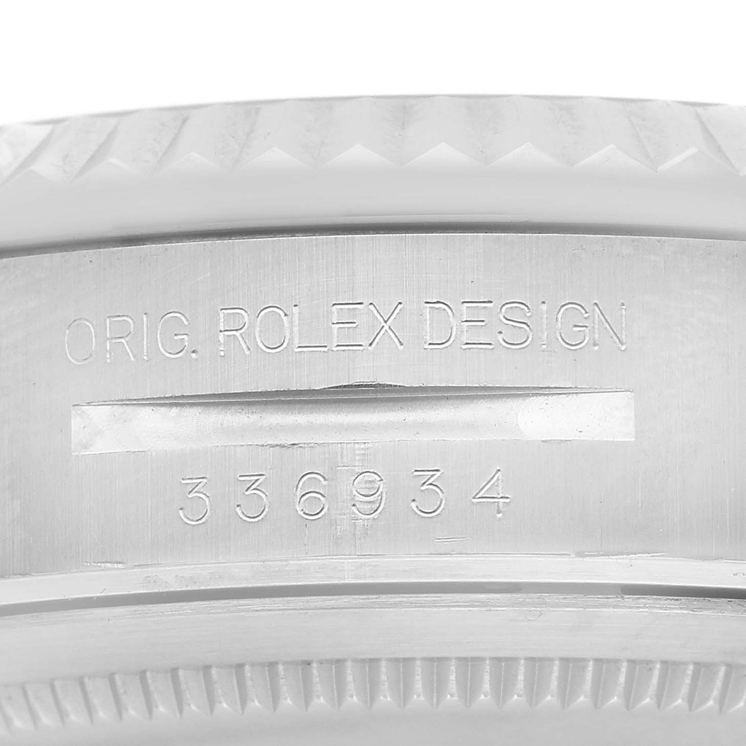 The image shows the side of a Rolex Sky-Dweller 336934 Men's Stainless Steel White Dial, focusing on the engraved design and serial numbers.