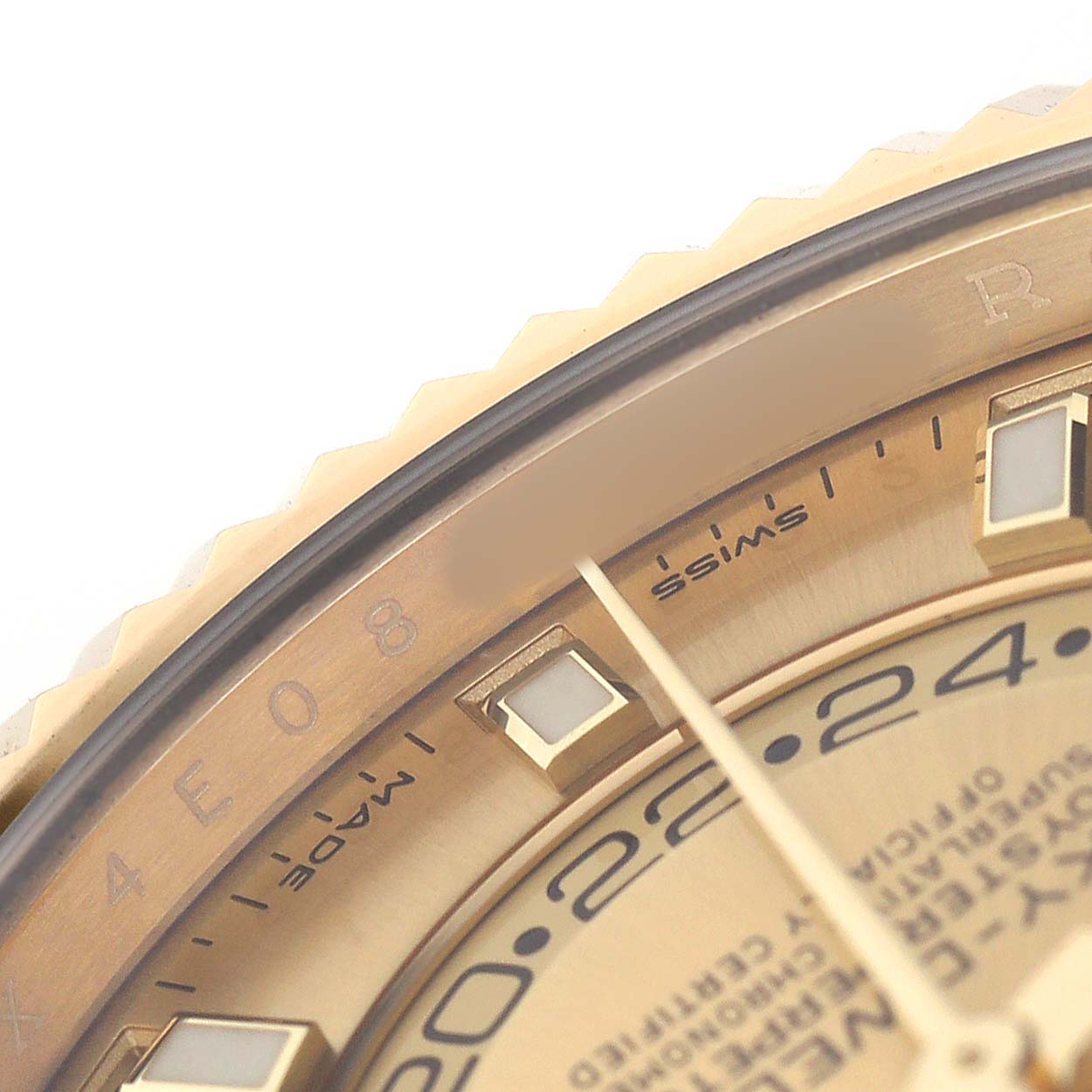 The image shows a close-up of the Rolex Sky-Dweller 326238 Men's Yellow Gold Champagne Dial's bezel, part of the dial, and a few hour markers.