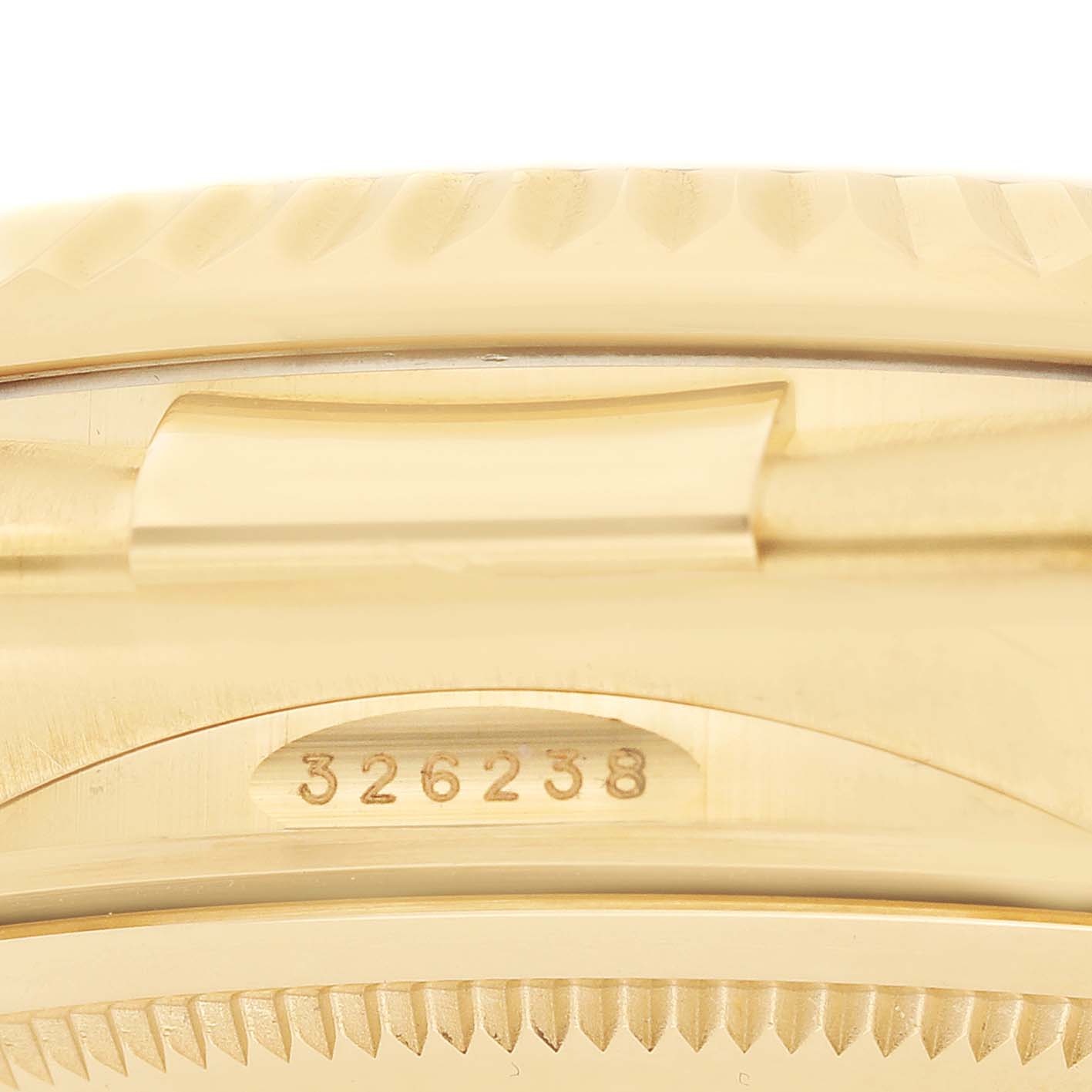 The image shows a close-up of the side of the Rolex Sky-Dweller 326238 Men's Yellow Gold Champagne Dial watch, highlighting the model number and part of the bezel.