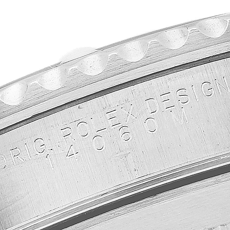 This image shows a close-up of the case side, engraving, and bezel teeth of a Rolex Submariner 14060M Men
s Stainless Steel Black Dial 14060M Men
s Stainless Steel Black Dial watch.