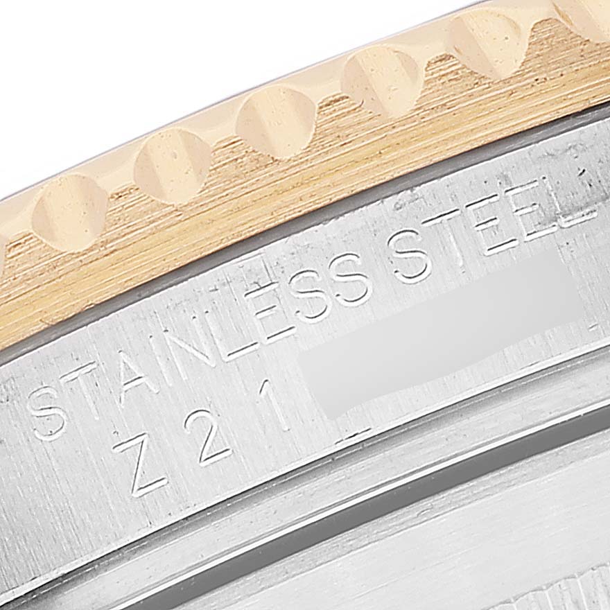 Close-up of the bezel and case edge of a Rolex Submariner 16613 Men
s Steel and Gold (two tone) Blue Dial 16613 Men
s Steel and Gold (two tone) Blue Dial, showing engraving details.