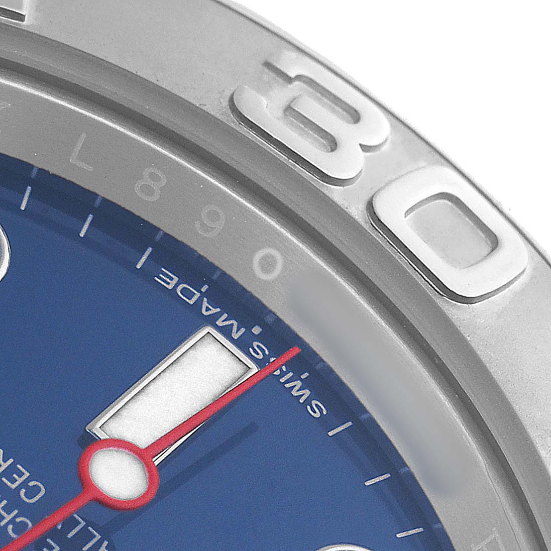 The image shows a close-up of the Rolex Yacht-Master 116622 Men's Stainless Steel Blue Dial watch's bezel, dial, and minute hand from an angled perspective.