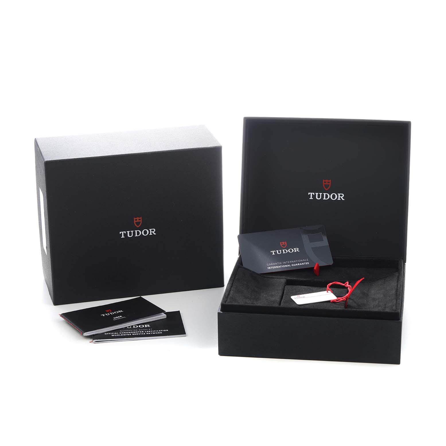 The image shows the packaging and accessories for a Tudor Heritage Black Bay 79830RB Men's Stainless Steel Silver Dial watch, featuring the outer box, inner box, and a warranty card.