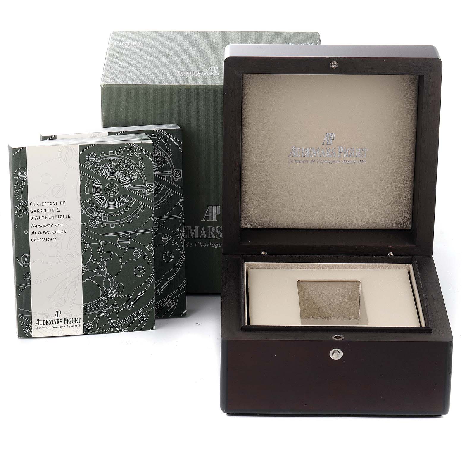 The image shows the packaging and accessories, including the box and manuals, for a Royal Oak model by Audemars Piguet.