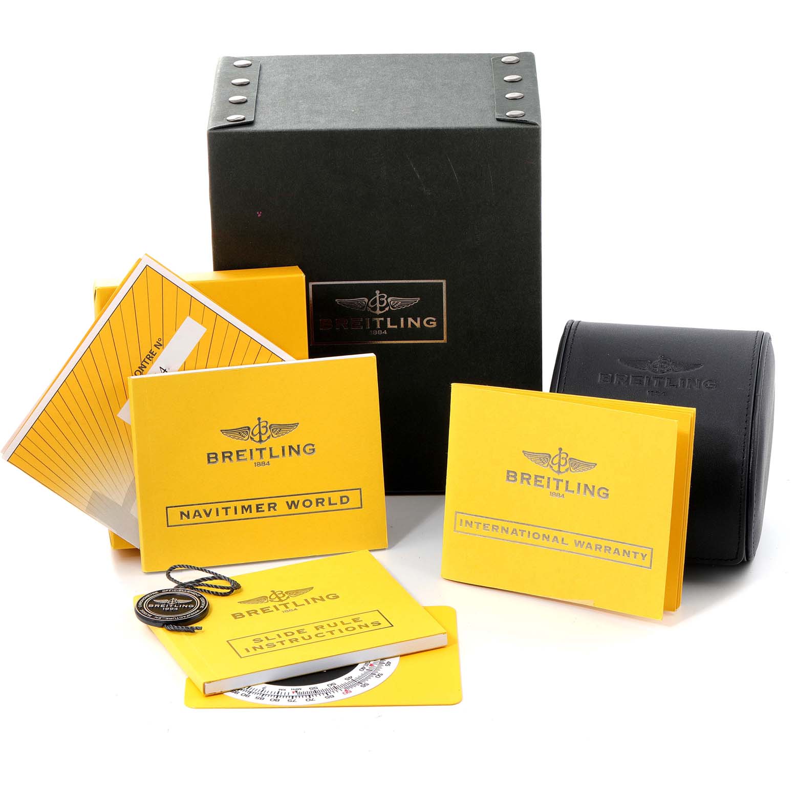 The image shows Breitling Navitimer A24322 Men
s Stainless Steel Black Dial A24322 Men
s Stainless Steel Black Dial model accessories including manuals, warranty cards, a tag, and storage boxes.