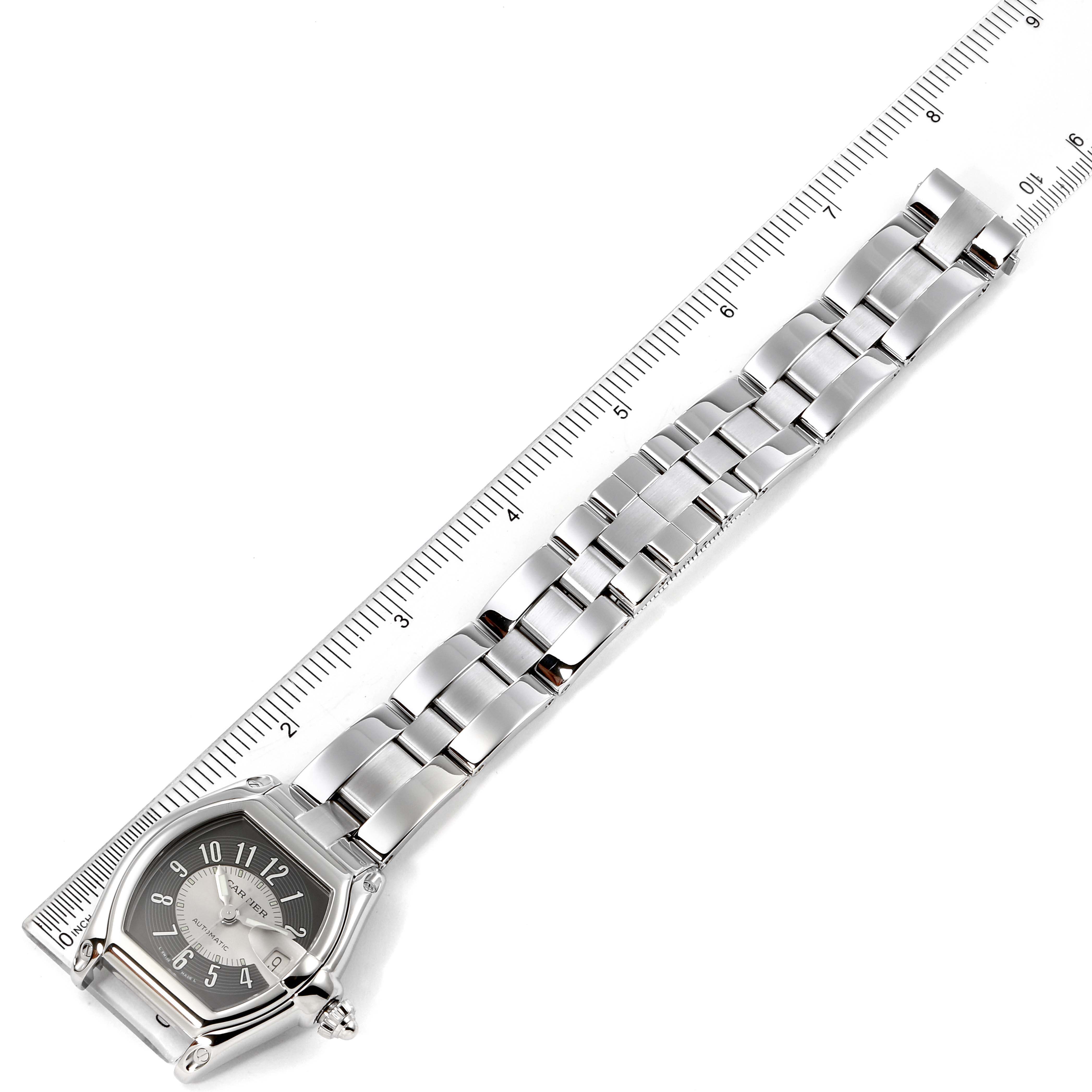 The image shows a Cartier Roadster W62001V3 Men's Stainless Steel Black Dial W62001V3 Men's Stainless Steel Black Dial watch laid flat, displaying the full length of its bracelet next to a ruler.