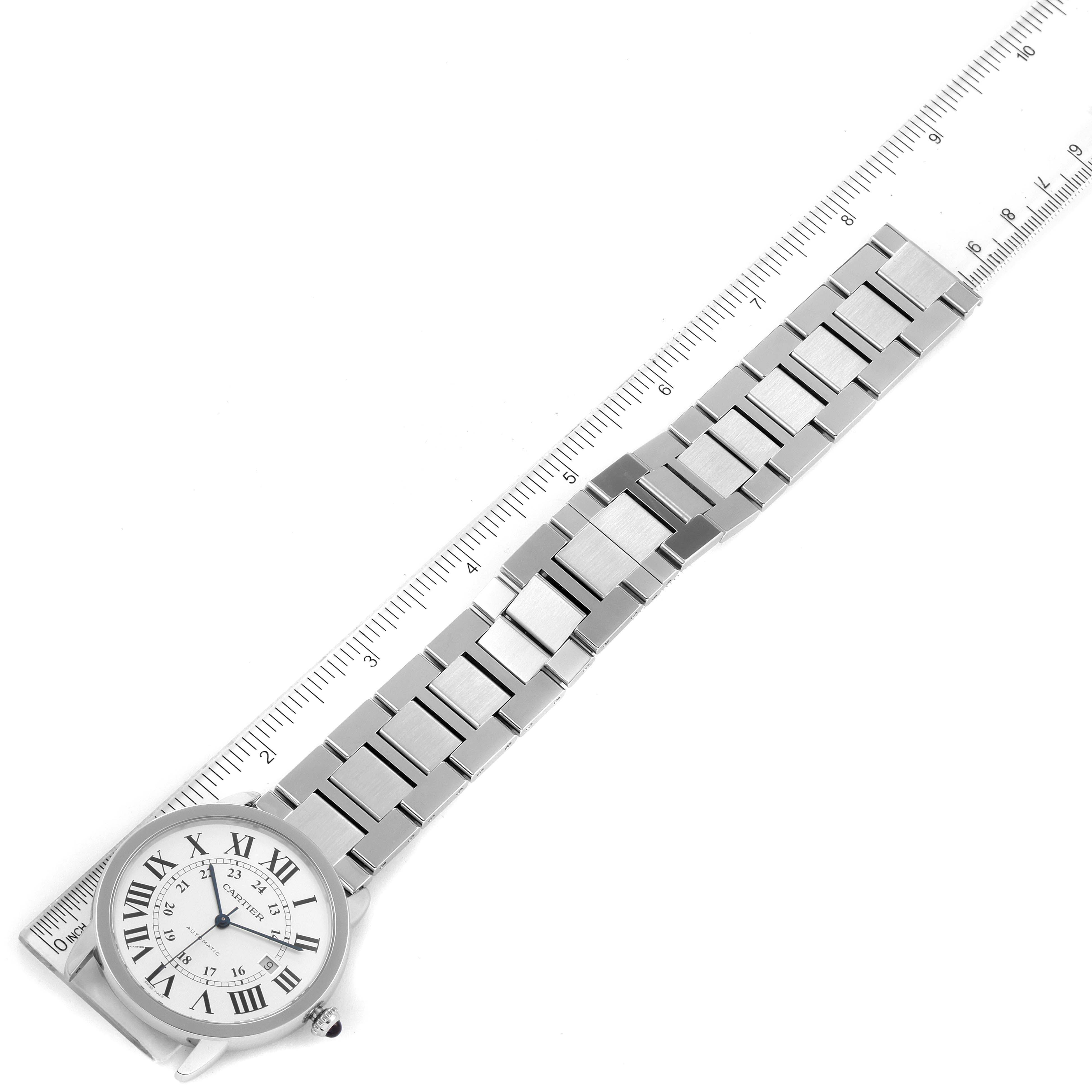 The image shows a top view of a Cartier Ronde W6701011 Men
s Stainless Steel Silver Dial W6701011 Men
s Stainless Steel Silver Dial watch with a metal bracelet laid next to a ruler for measurement.