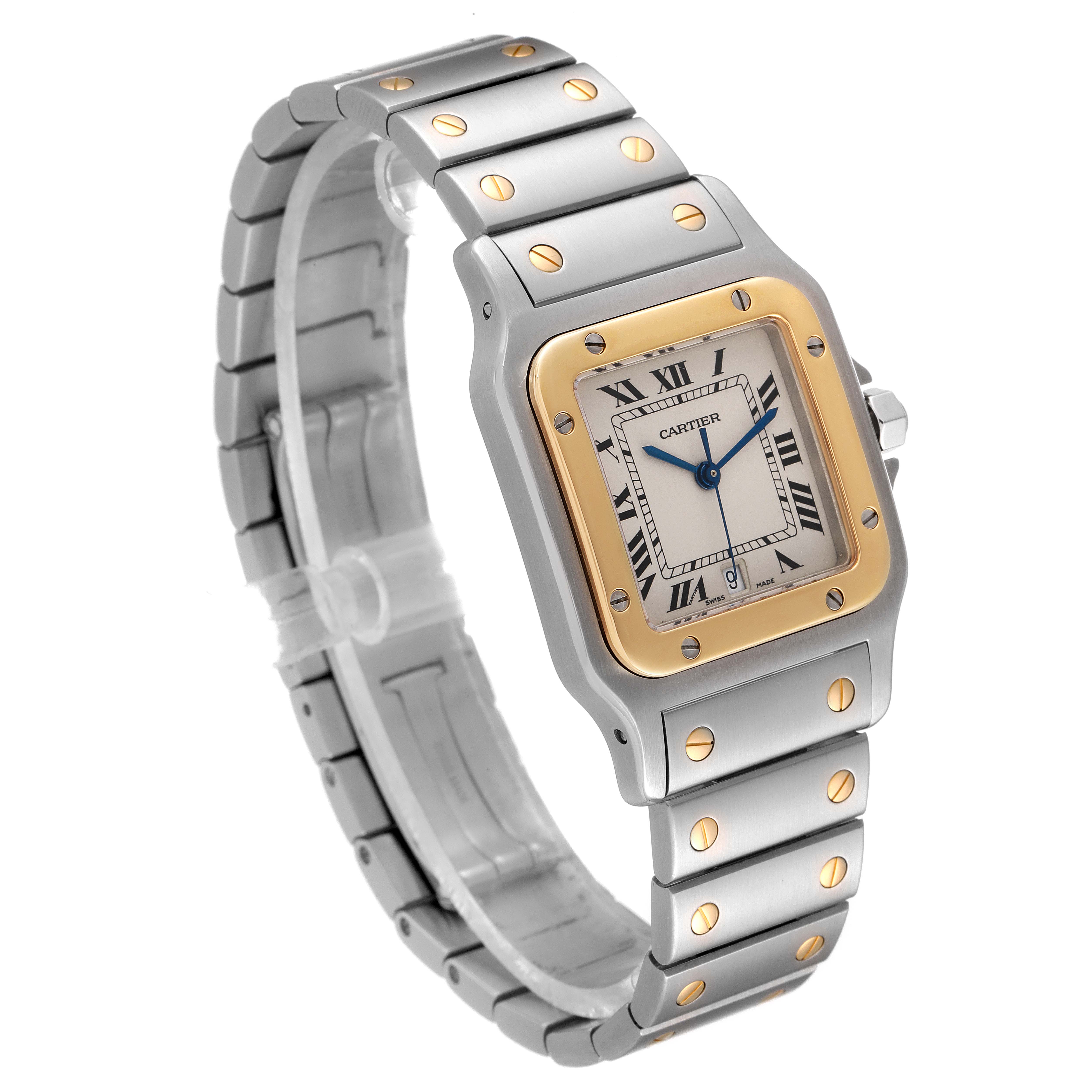 The image shows a Cartier Santos W20011C4 Men
s Steel and Gold (two tone) Silver Dial W20011C4 Men
s Steel and Gold (two tone) Silver Dial watch angled to display its face, bezel, and part of the metal band.