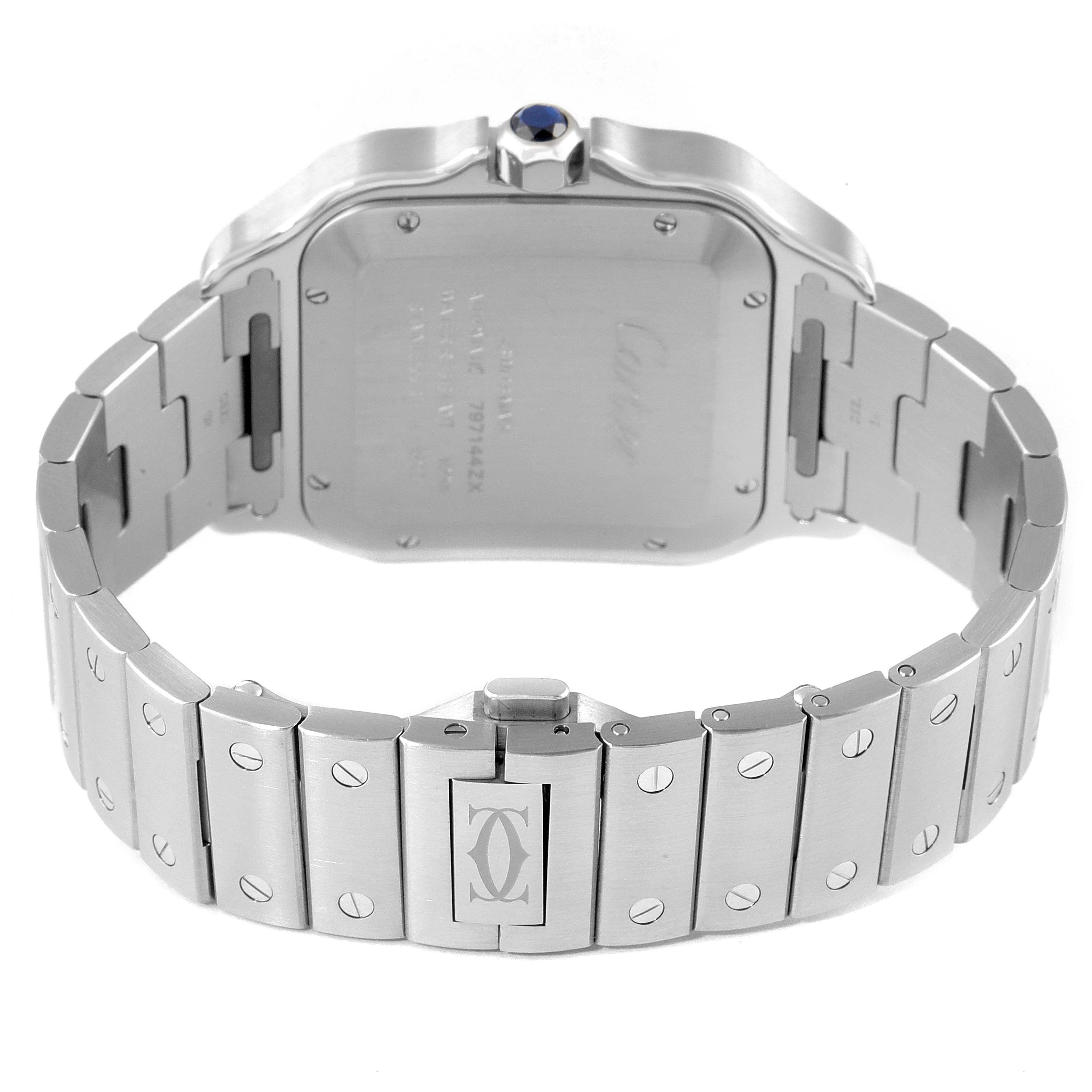 The image displays the back angle of a Santos model watch by Cartier, focusing on the caseback and metal bracelet.