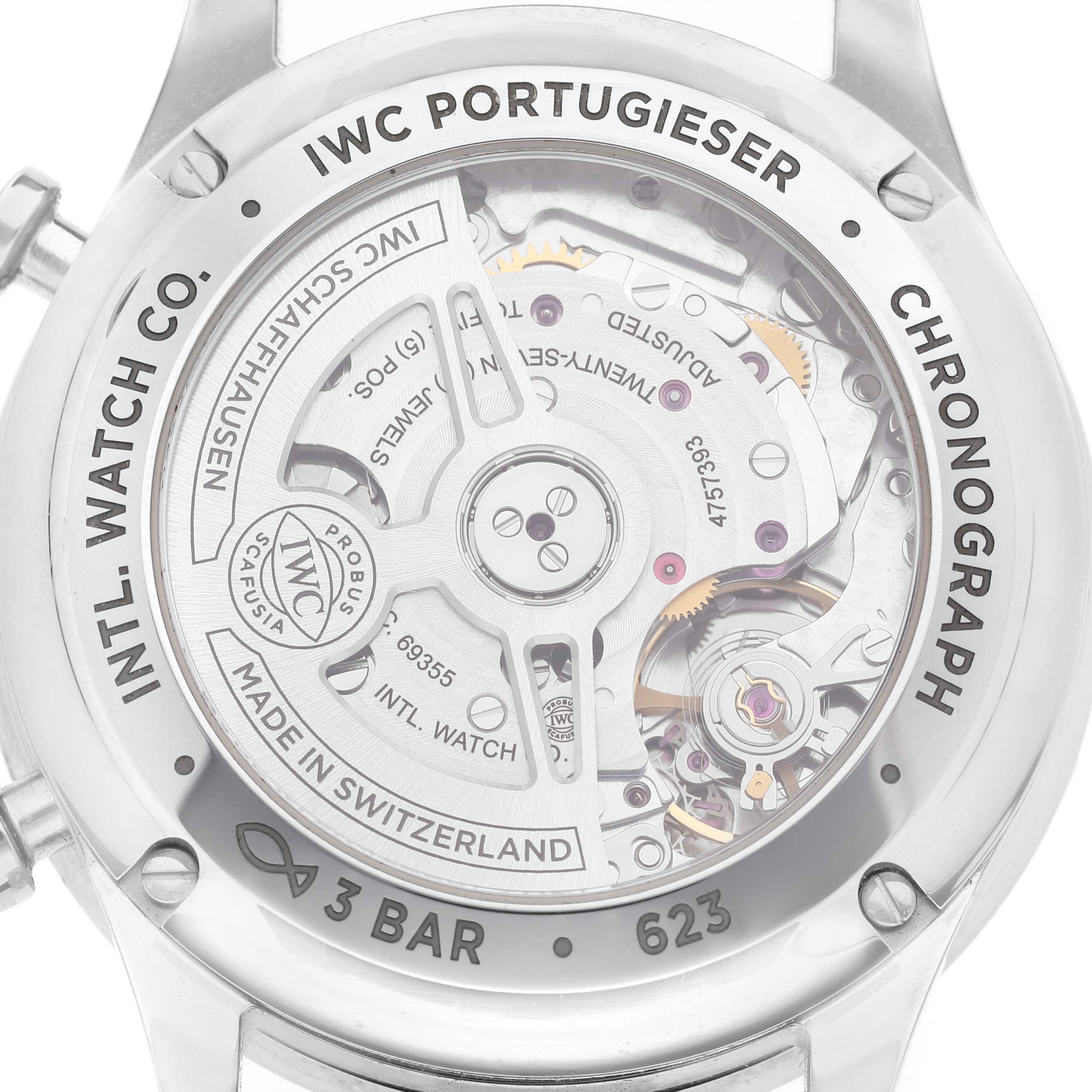The image shows the back of the IWC Portugieser Chronograph, revealing its intricate mechanical movement and inscriptions.