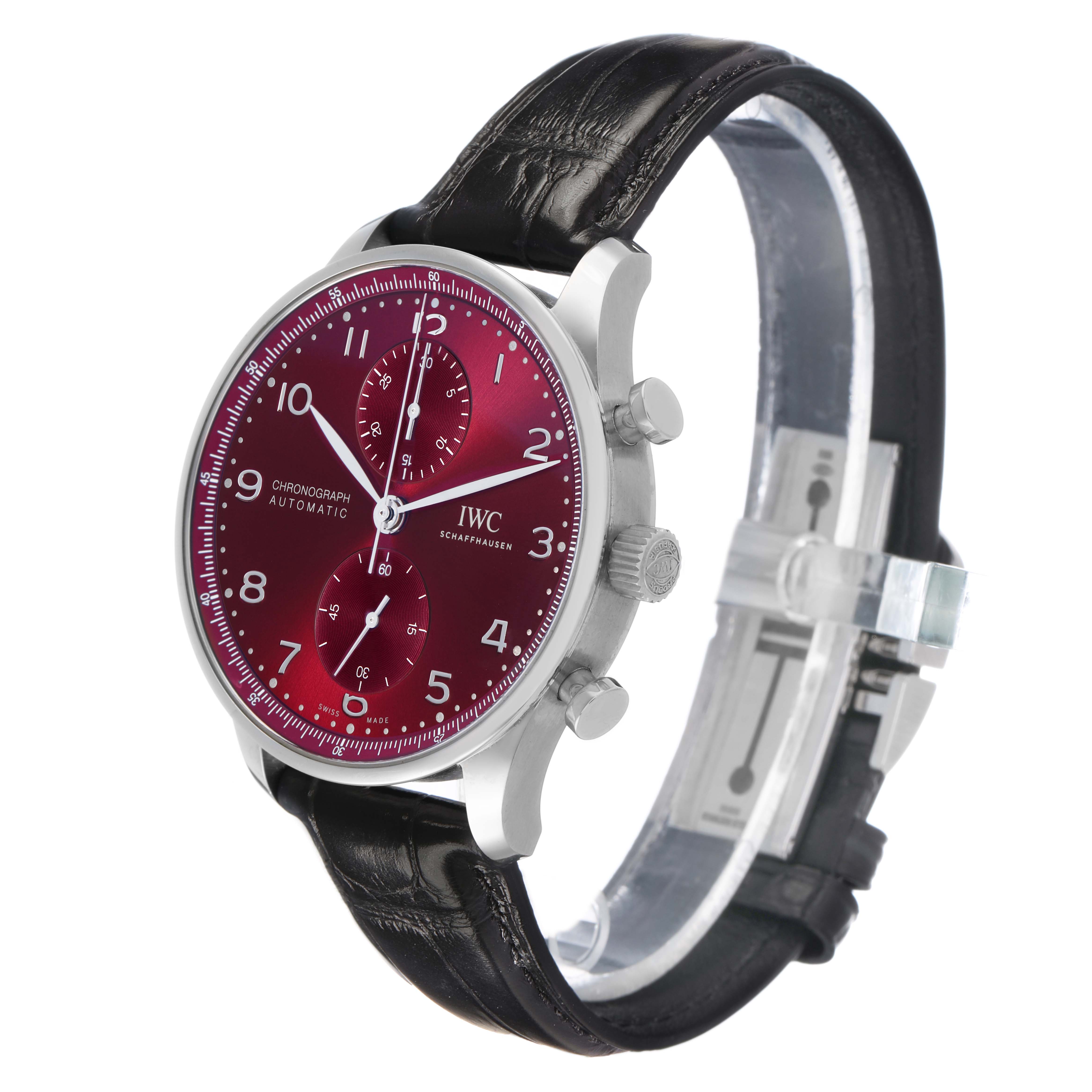 The IWC Portuguese IW371616 Men's Stainless Steel Red Dial watch is shown at a side angle, displaying its red dial, chronograph subdials, and black leather strap.