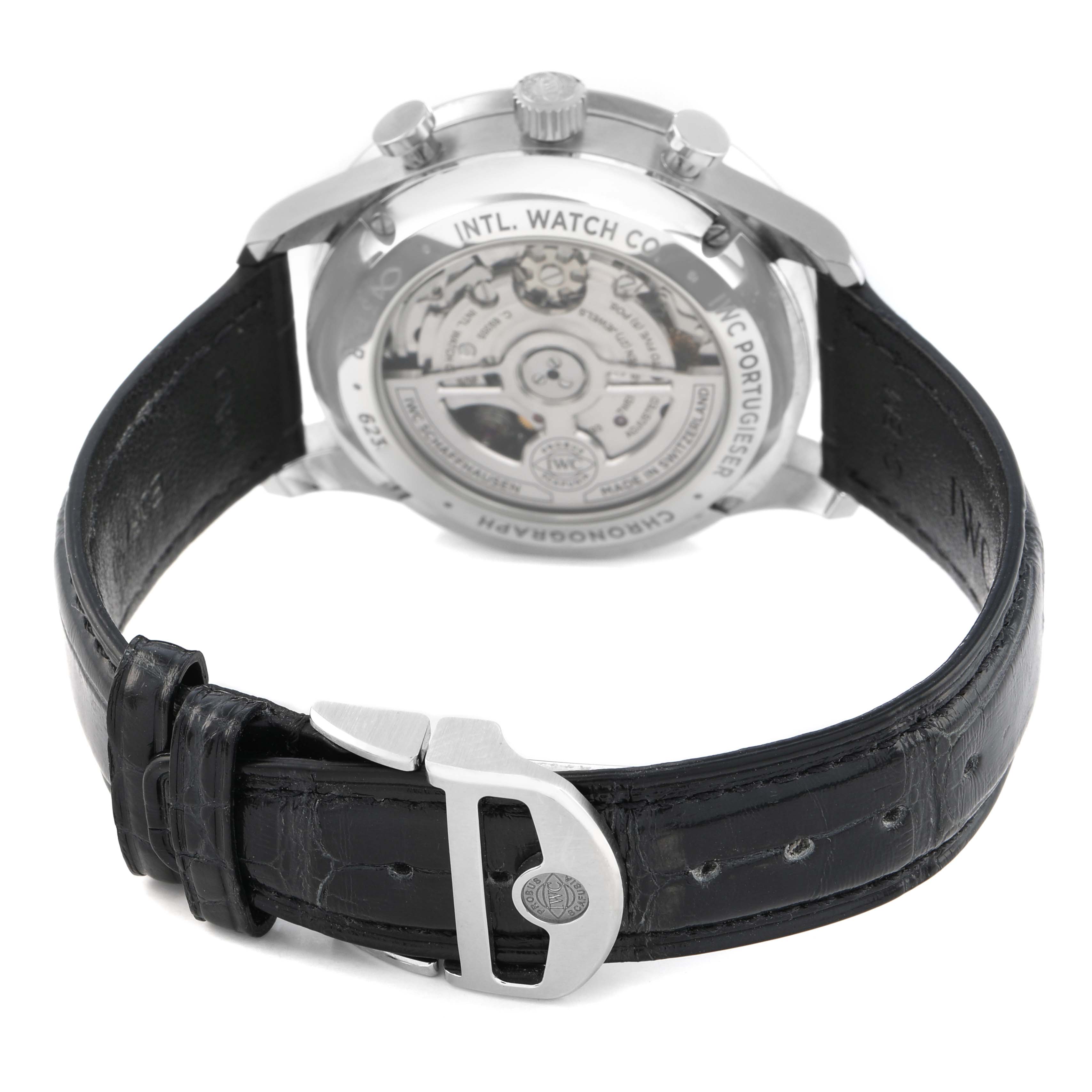 The IWC Portuguese IW371616 Men's Stainless Steel Red Dial watch is shown from the back, displaying the movement and black leather strap with a clasp.