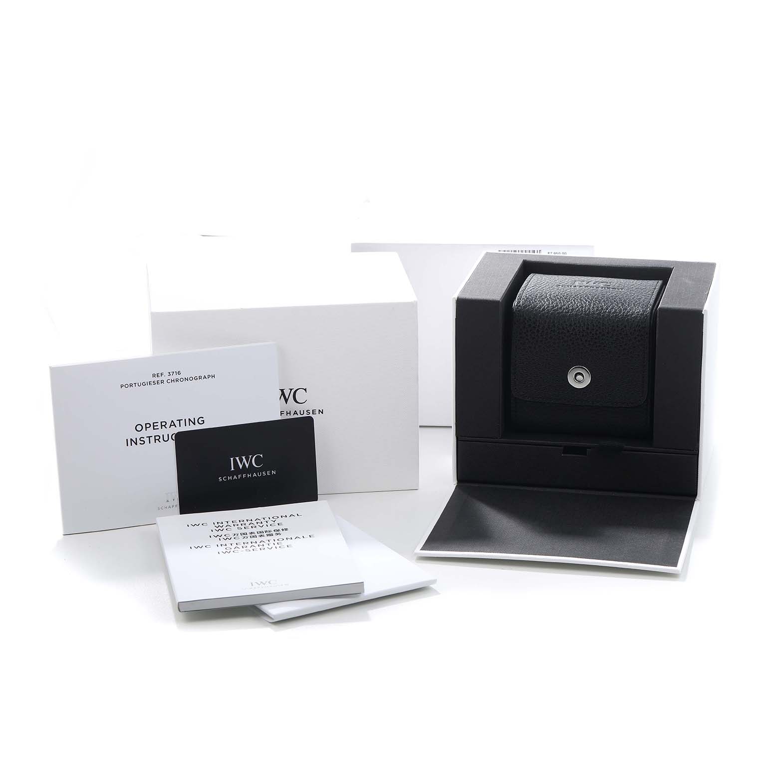 The image shows the IWC Portuguese IW371616 Men's Stainless Steel Red Dial model packaging and accessories, including a box and instruction booklets.