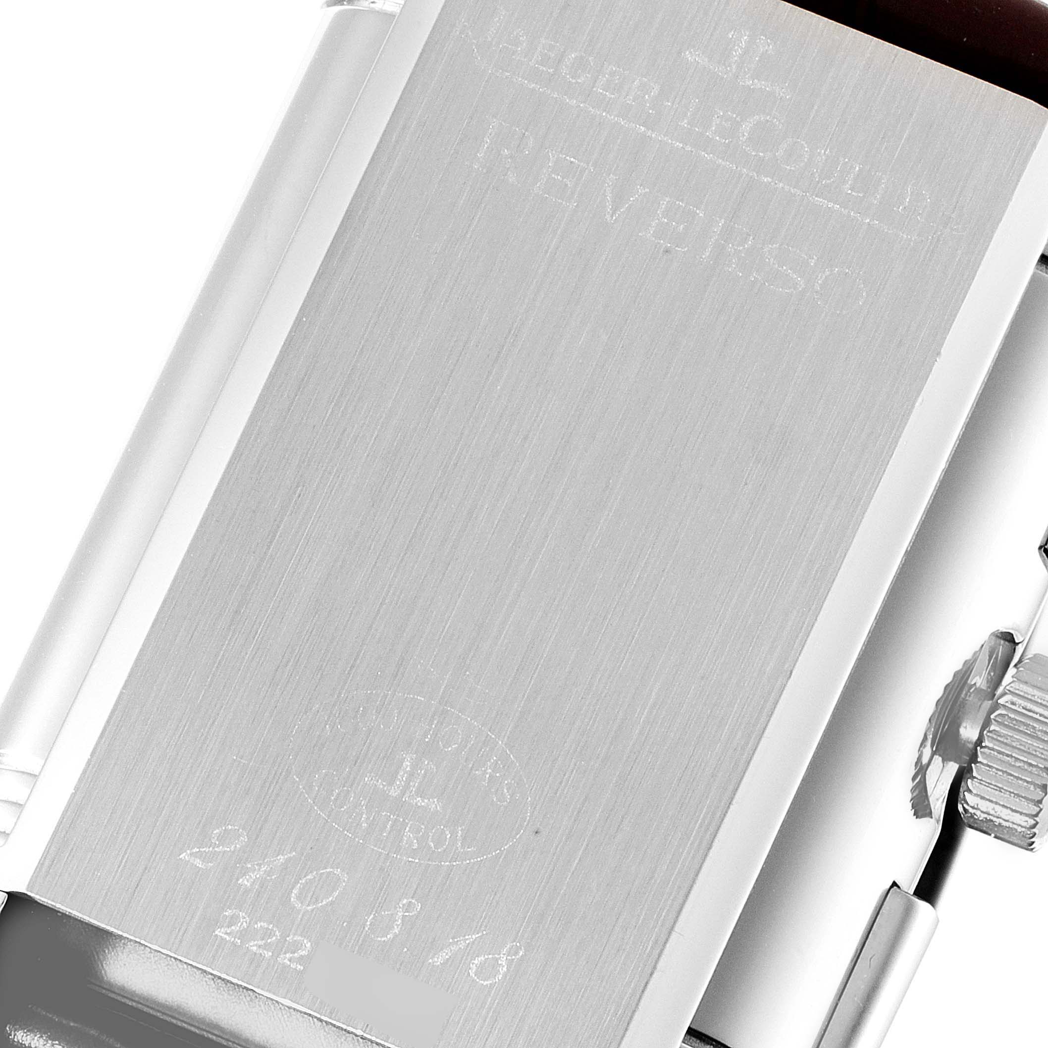The image shows the back case and crown of a Jaeger LeCoultre Reverso Q3028420 Men
s Stainless Steel Silver Dial Q3028420 Men
s Stainless Steel Silver Dial watch, focusing on engraved details.
