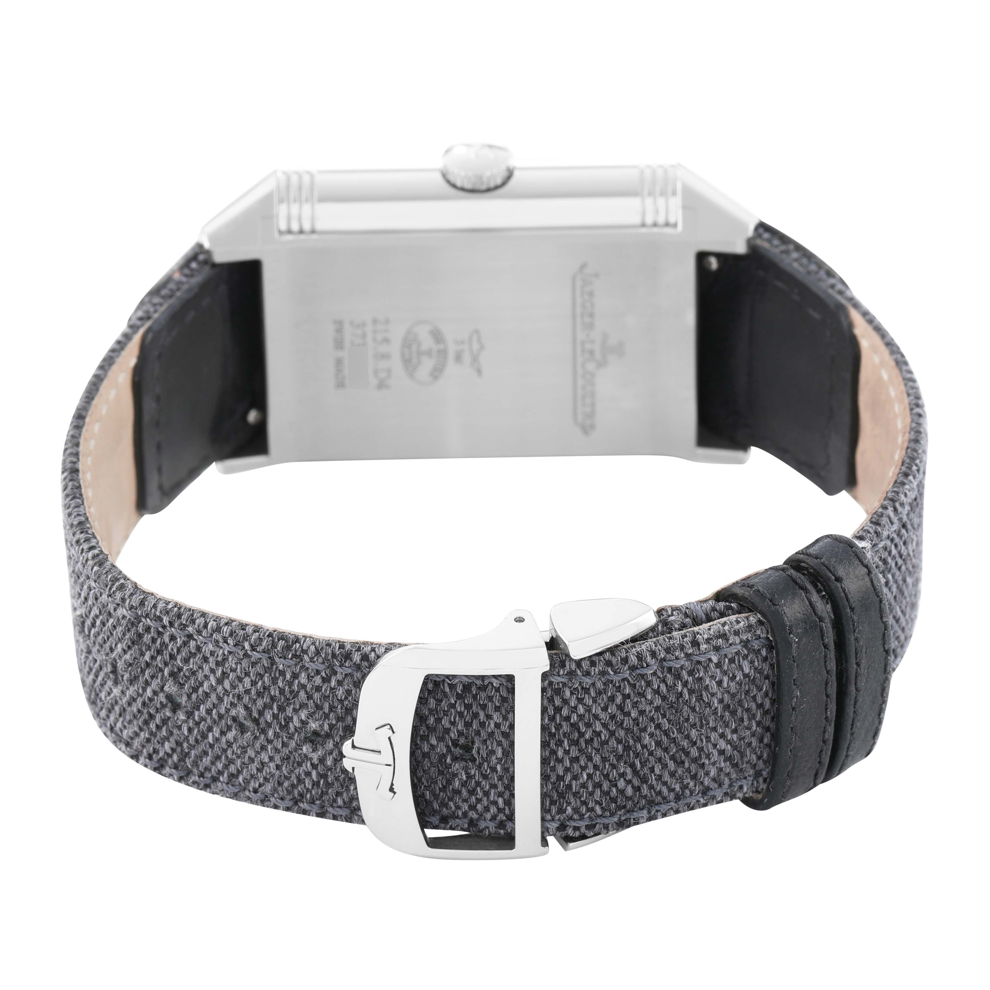 The Reverso model by Jaeger LeCoultre is shown from the back, highlighting the case, crown, and fabric strap with a buckle.