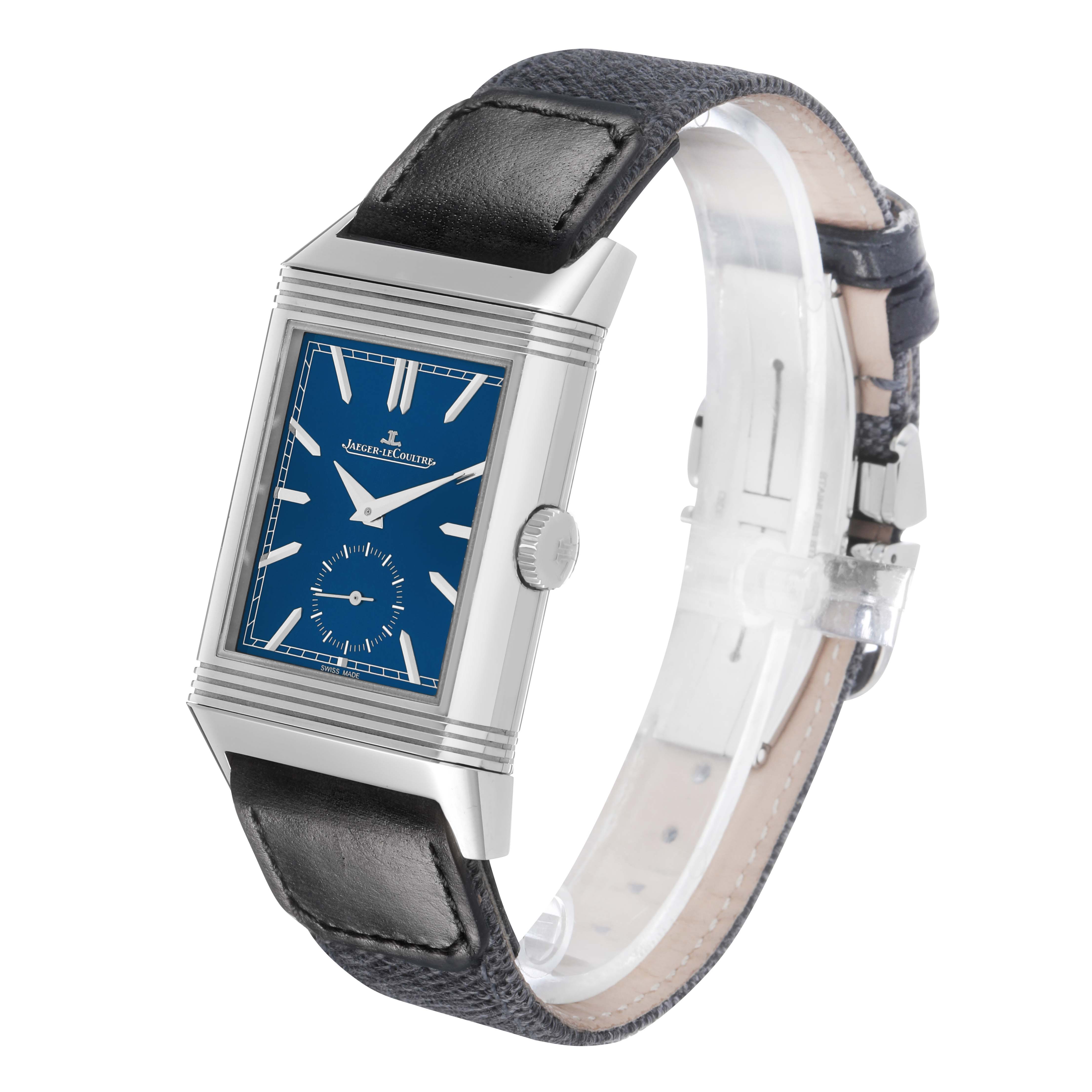 The Jaeger-LeCoultre Reverso watch is shown at a slight angle, displaying the blue dial, silver case, side crown, and black leather strap.