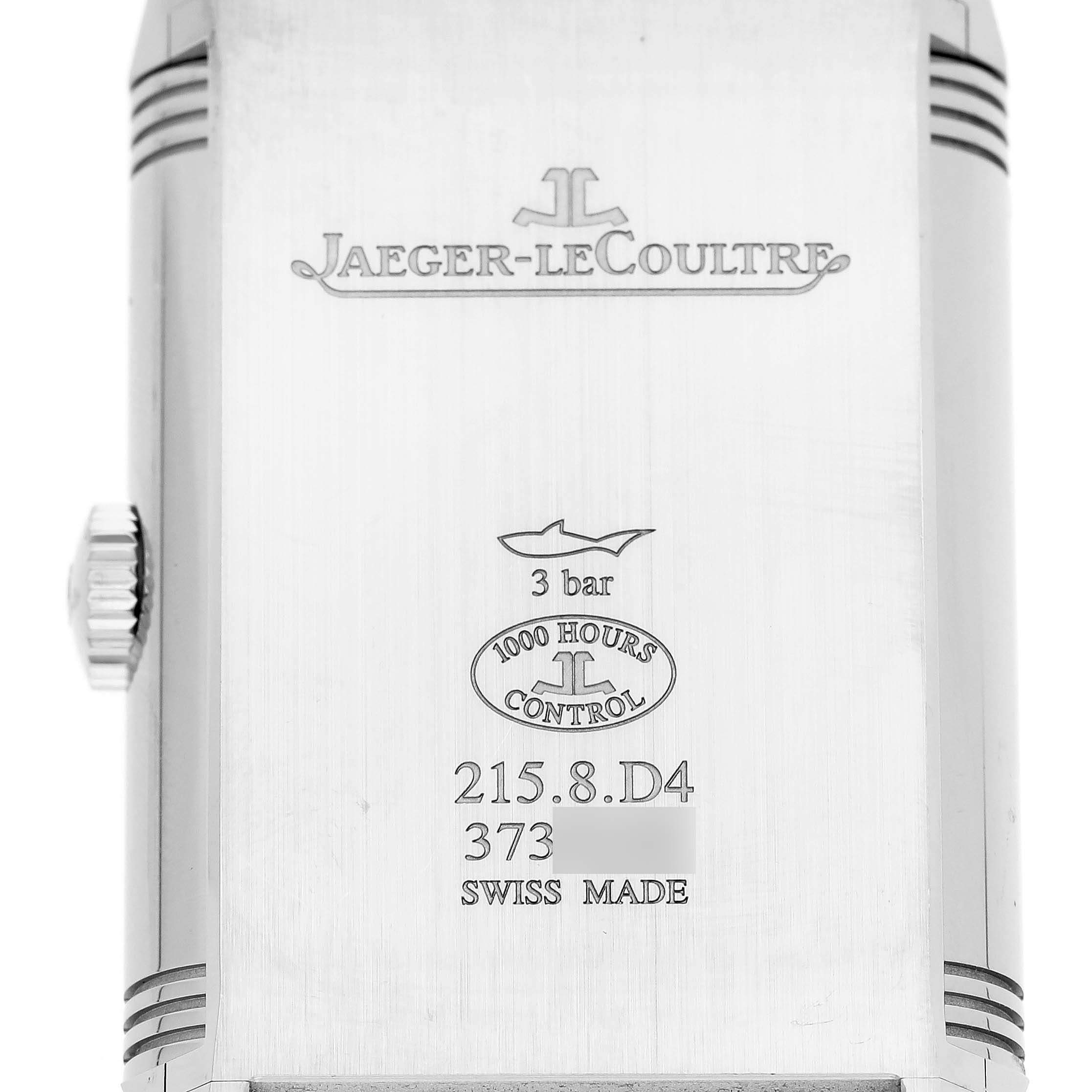 The image shows the back of a Jaeger-LeCoultre Reverso watch with engravings and branding details.