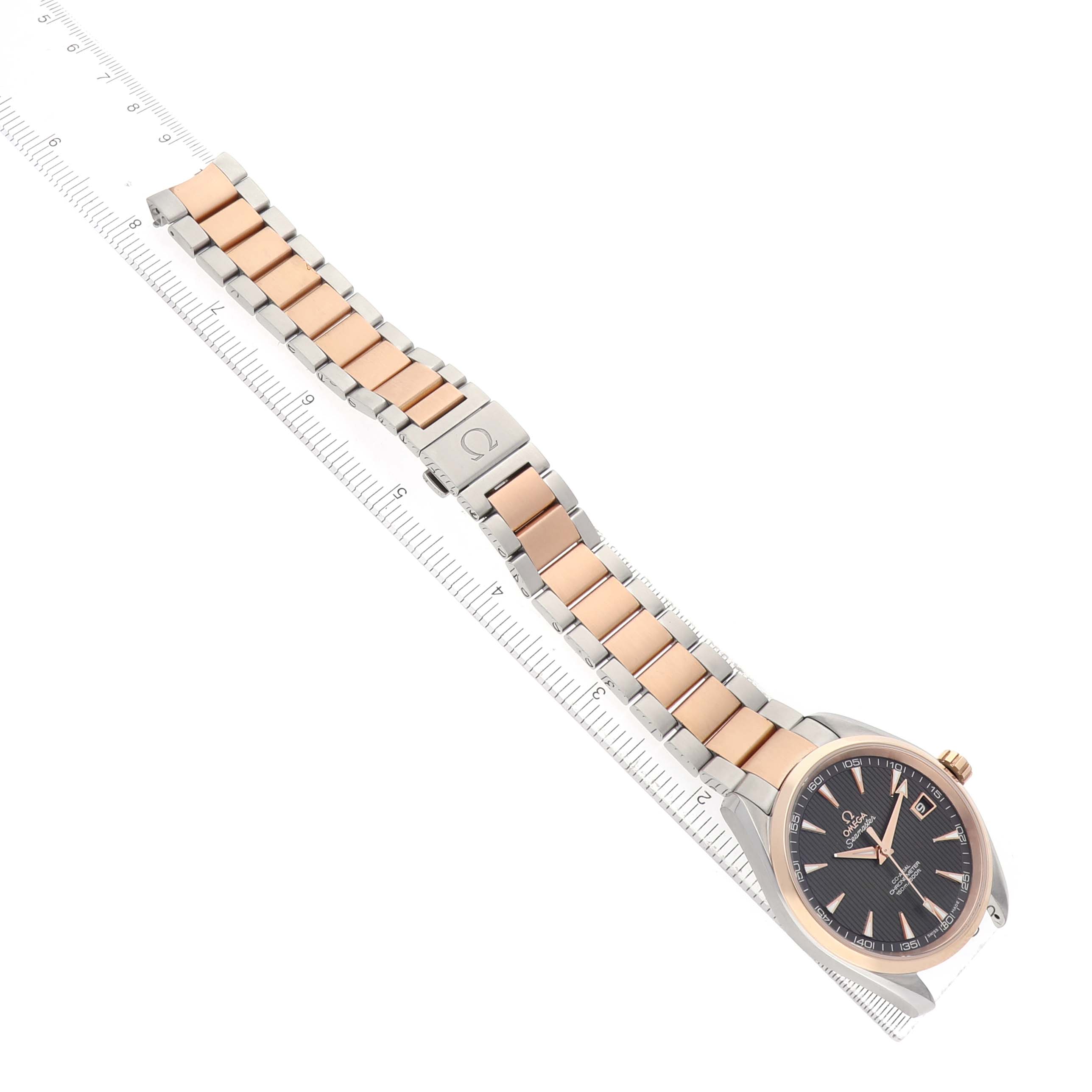 The Omega Aqua Terra 231.20.42.21.06.001 Men's Stainless Steel Grey Dial watch is displayed at an angle showcasing its face, bracelet, and clasp against a ruler for size reference.