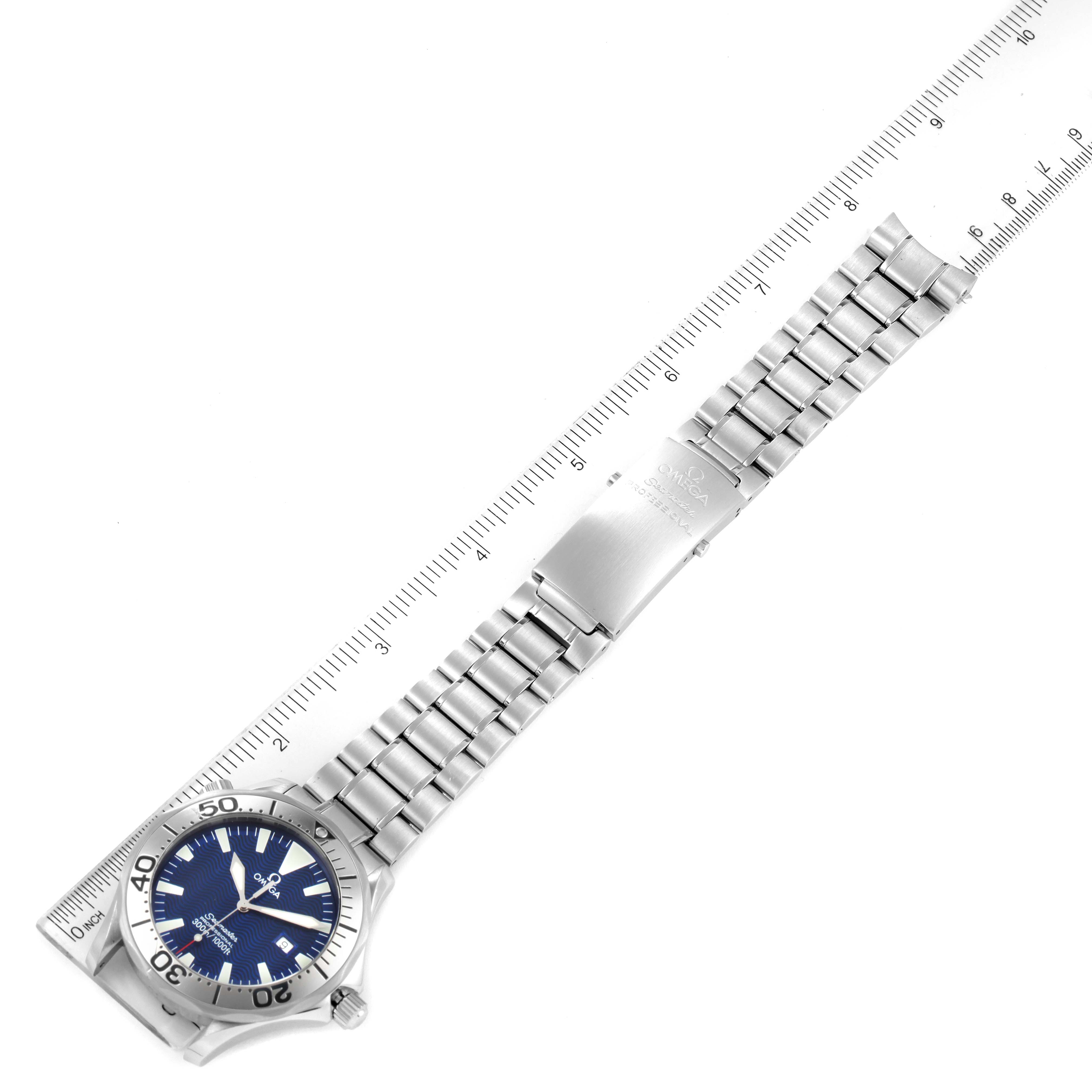 The image shows the entire Omega Seamaster 2265.80.00 Men's Stainless Steel Blue Dial 2265.80.00 Men's Stainless Steel Blue Dial watch laid flat next to a ruler, displaying the bracelet and the face of the watch.