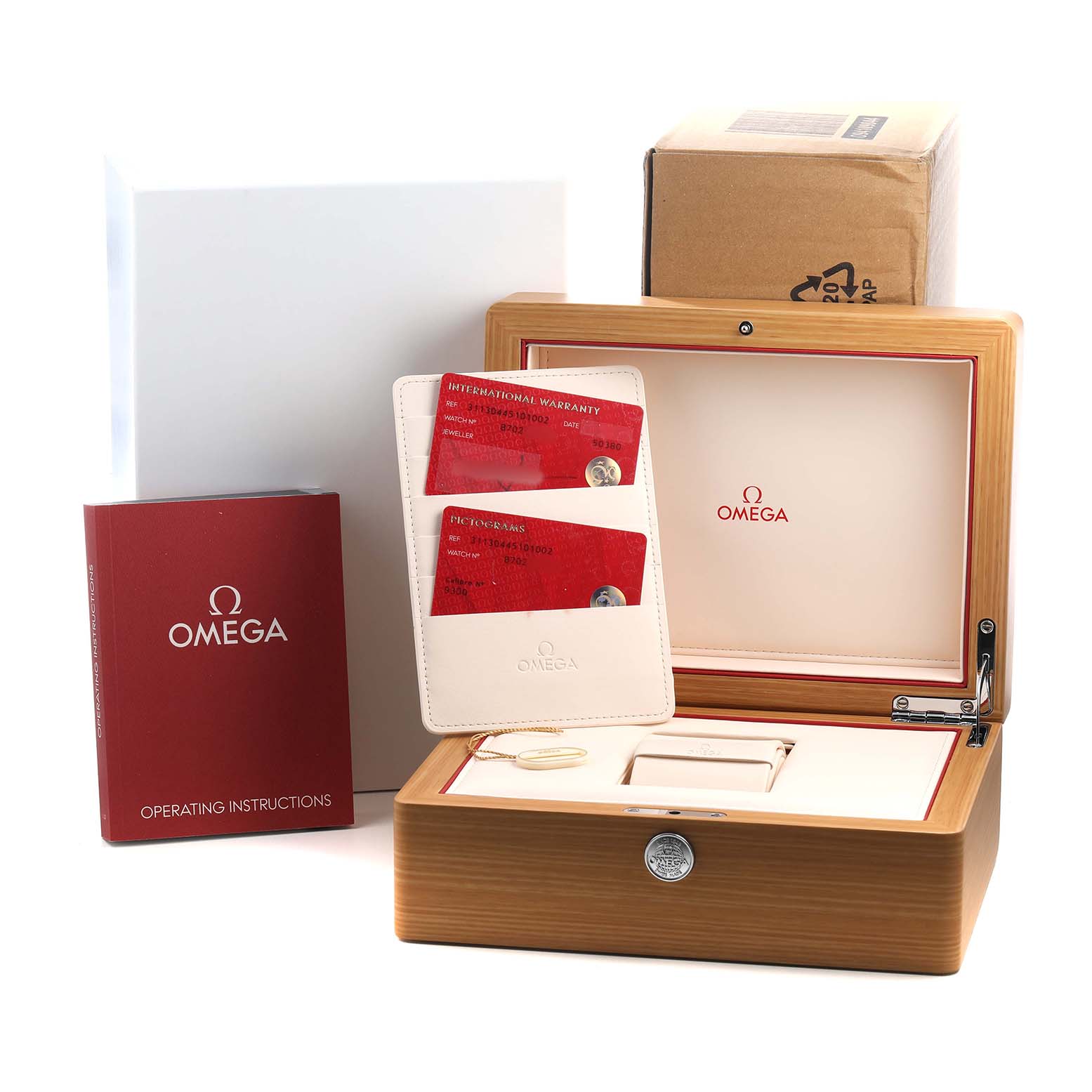 The image shows the Omega Speedmaster 311.30.44.51.01.002 Men's Stainless Steel Black Dial packaging, including a wooden box, warranty cards, and an instruction booklet, viewed from the front.