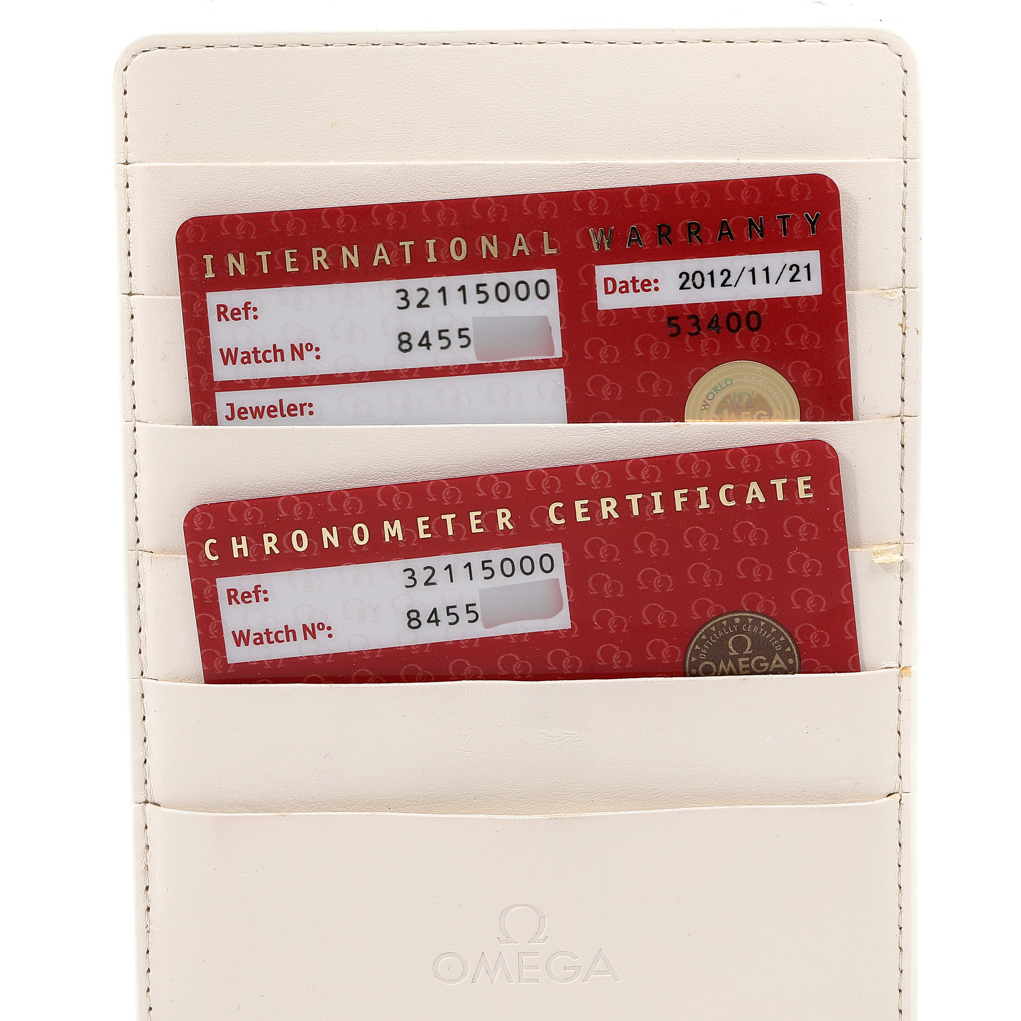 The image shows the international warranty and chronometer certificate cards for an Omega Speedmaster 3211.50.00 Men
s Stainless Steel Black Dial 3211.50.00 Men
s Stainless Steel Black Dial watch.