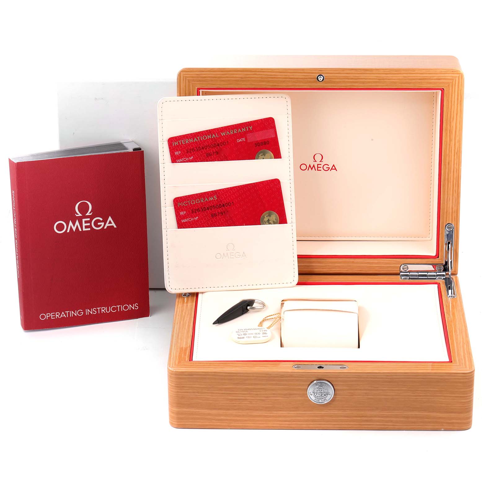 The image shows an Omega Speedmaster 326.30.40.50.04.001 Men's Stainless Steel White Dial 326.30.40.50.04.001 Men's Stainless Steel White Dial watch box, operating instructions, warranty cards, and a watch holder from a top-down angle.