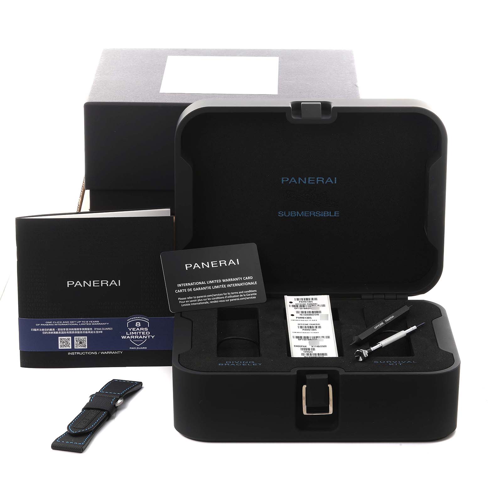The image shows a Panerai Luminor PAM01305 Men
s Stainless Steel Black Dial PAM01305 Men
s Stainless Steel Black Dial watch case with tools, a warranty card, a booklet, and an additional strap from a front angle.