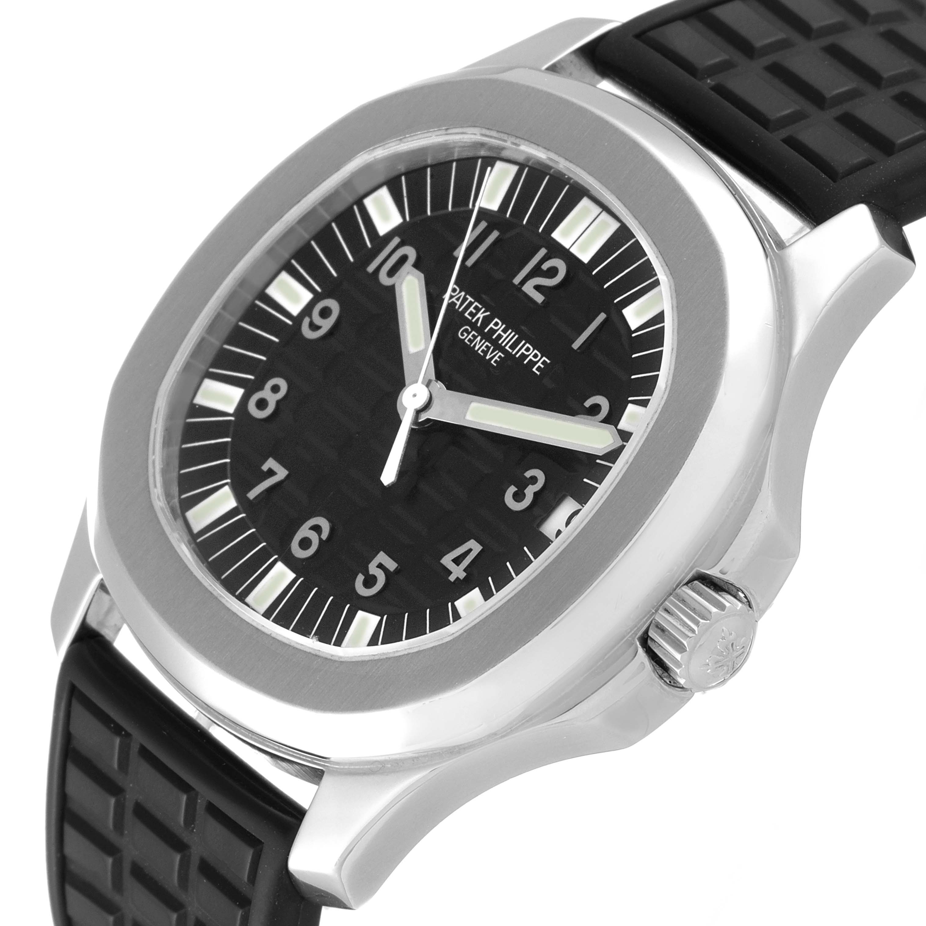 The image shows a close-up, side angle of the Patek Philippe Aquanaut 5065/1A-010 Men's Stainless Steel Black Dial 5065/1A-010 Men's Stainless Steel Black Dial watch, highlighting the dial, case, and crown.