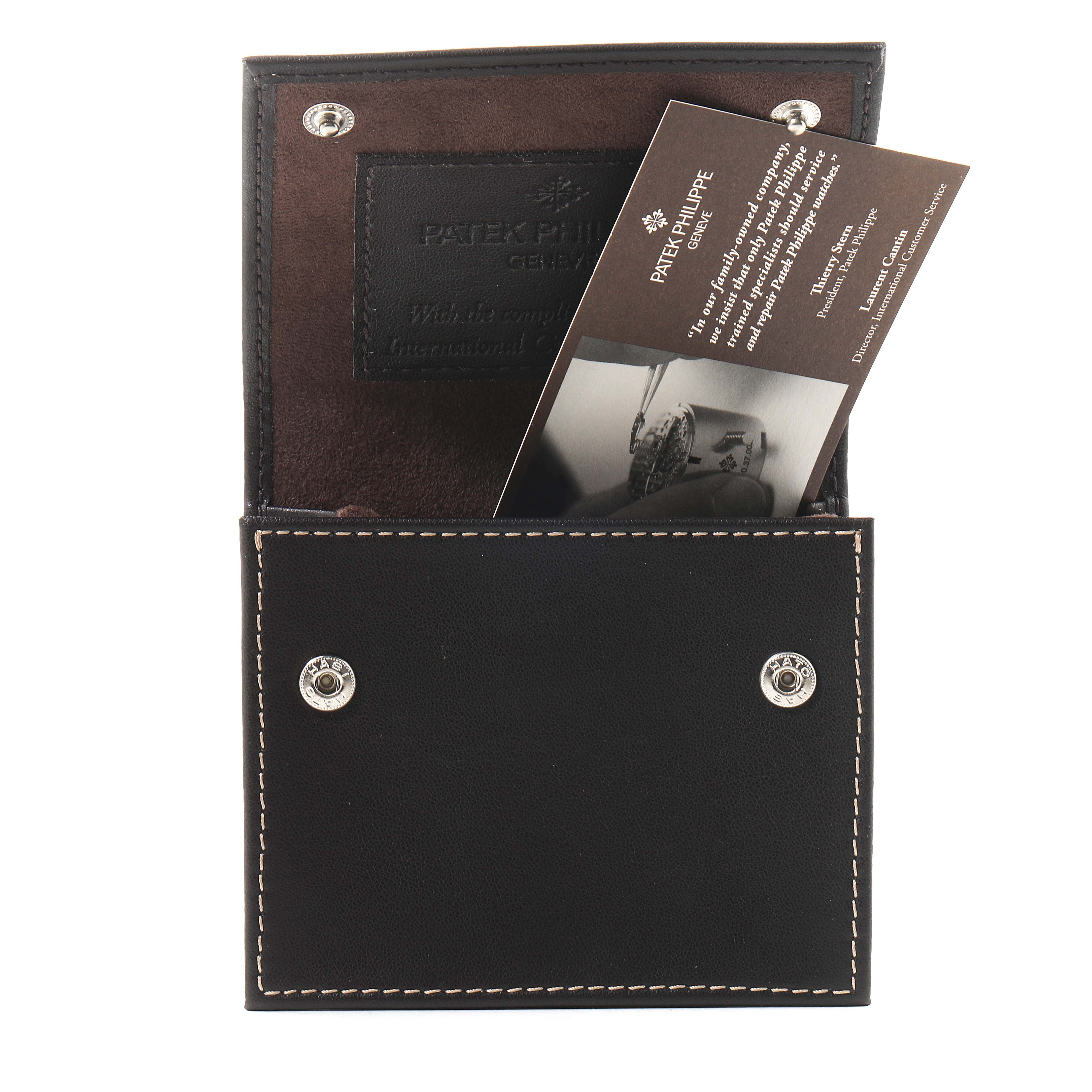 The image shows an open Patek Philippe Aquanaut 5067A Women's Stainless Steel White Dial 5067A Women's Stainless Steel White Dial watch case with documentation inside.