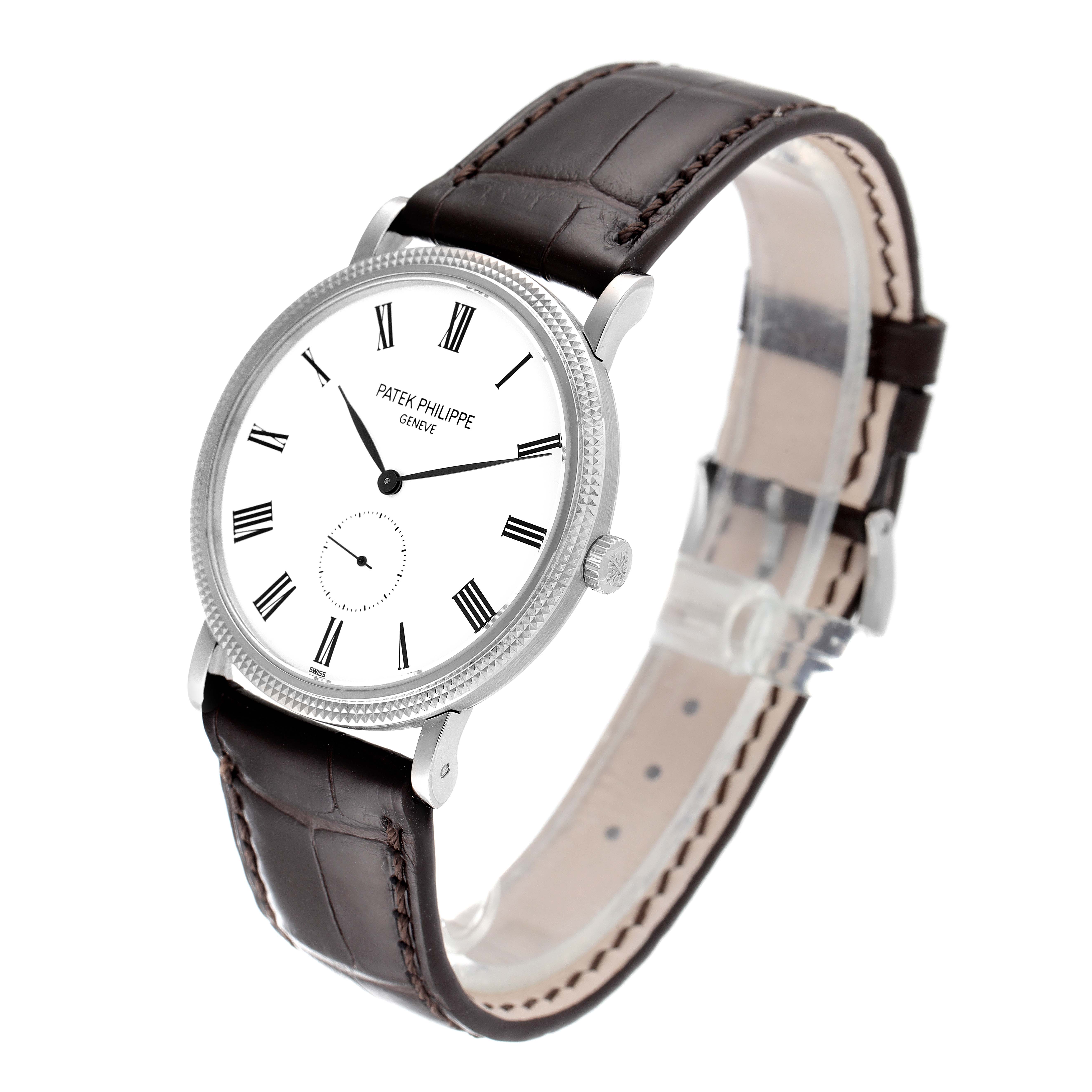 This image shows a Patek Philippe Calatrava 5119G Men
s White Gold White Dial 5119G Men
s White Gold White Dial watch at a slight angle, highlighting its face, bezel, crown, and leather strap.