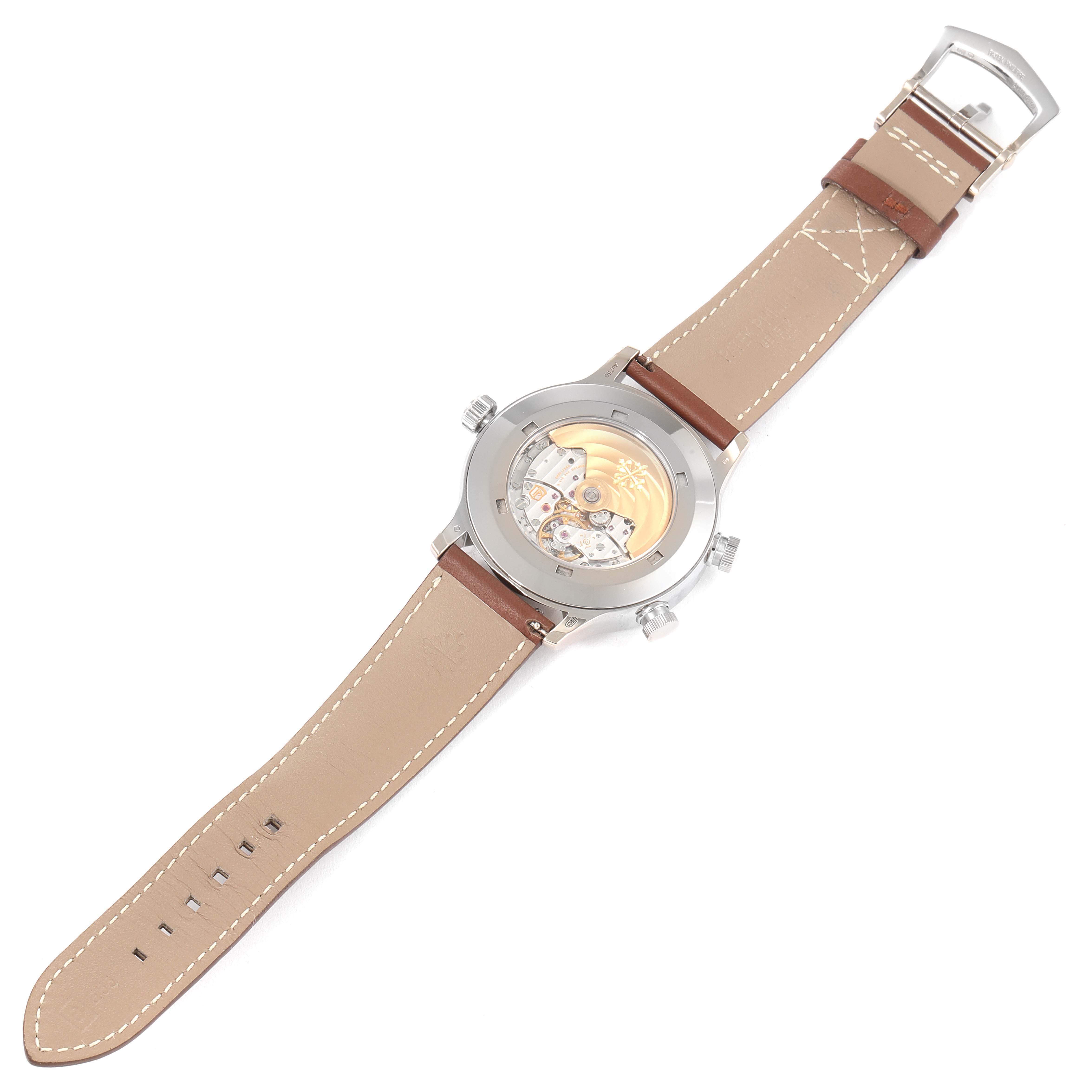 The image shows a Patek Philippe Calatrava 5524G Men's White Gold Blue Dial 5524G Men's White Gold Blue Dial watch from the back, highlighting its movement and brown leather strap.