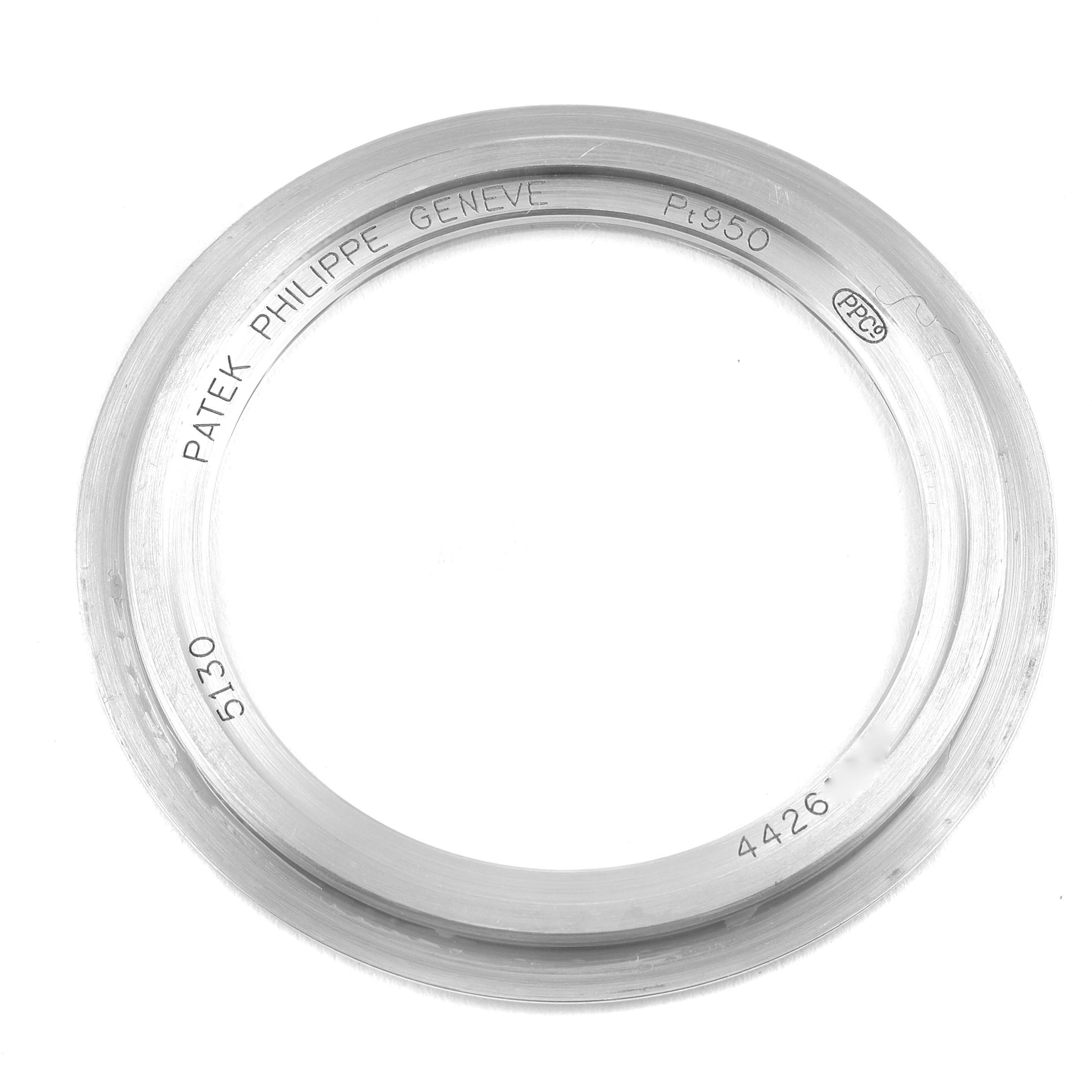 The image shows a detailed view of the bezel for a Patek Philippe Complications 5130P Men's Platinum Silver Dial 5130P Men's Platinum Silver Dial model 5130 watch, emphasizing the engravings.