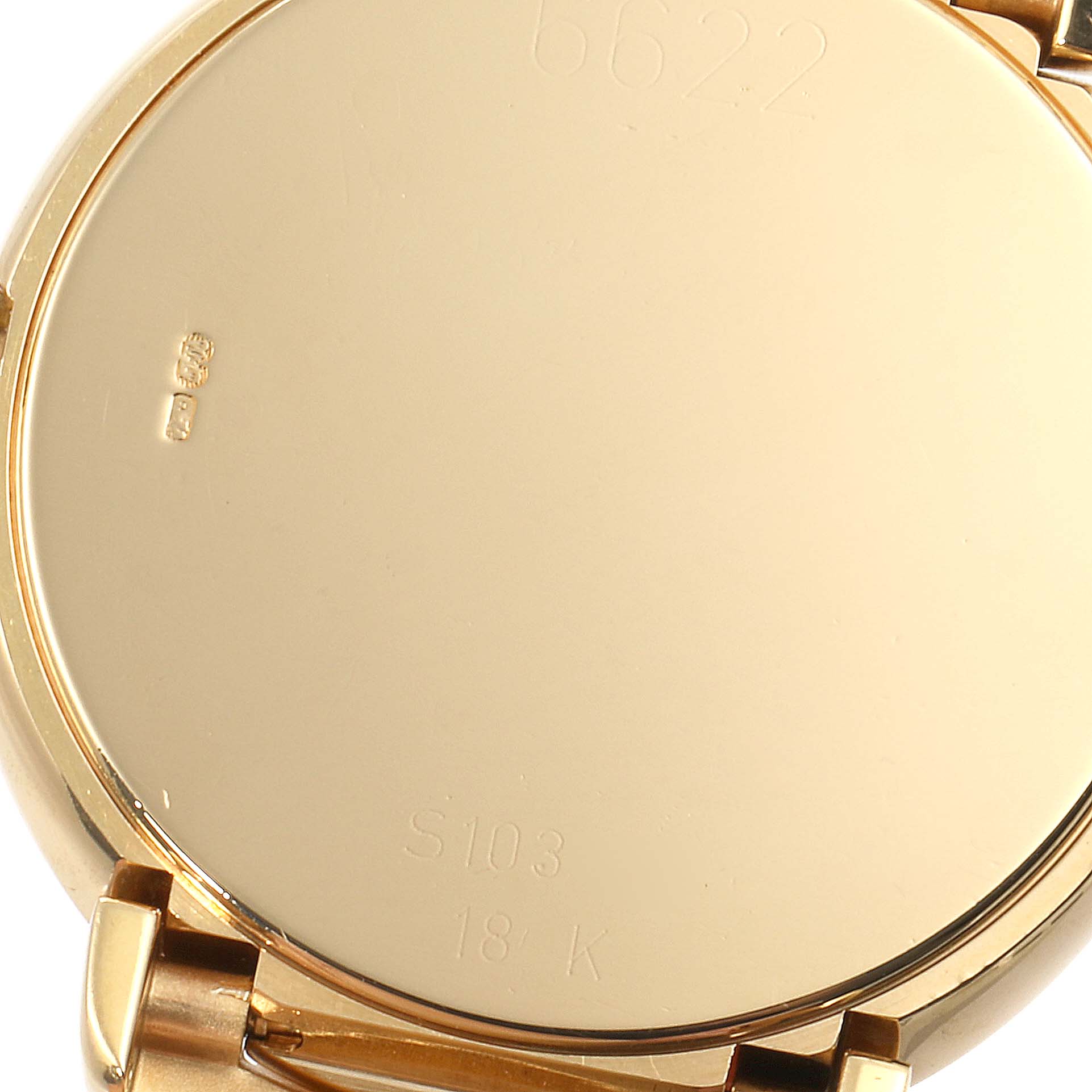 This is an image of the back case of a Rolex Cellini 6622 Men's Yellow Gold Grey Dial 6622 Men's Yellow Gold Grey Dial watch, showing its markings and part of the bracelet.