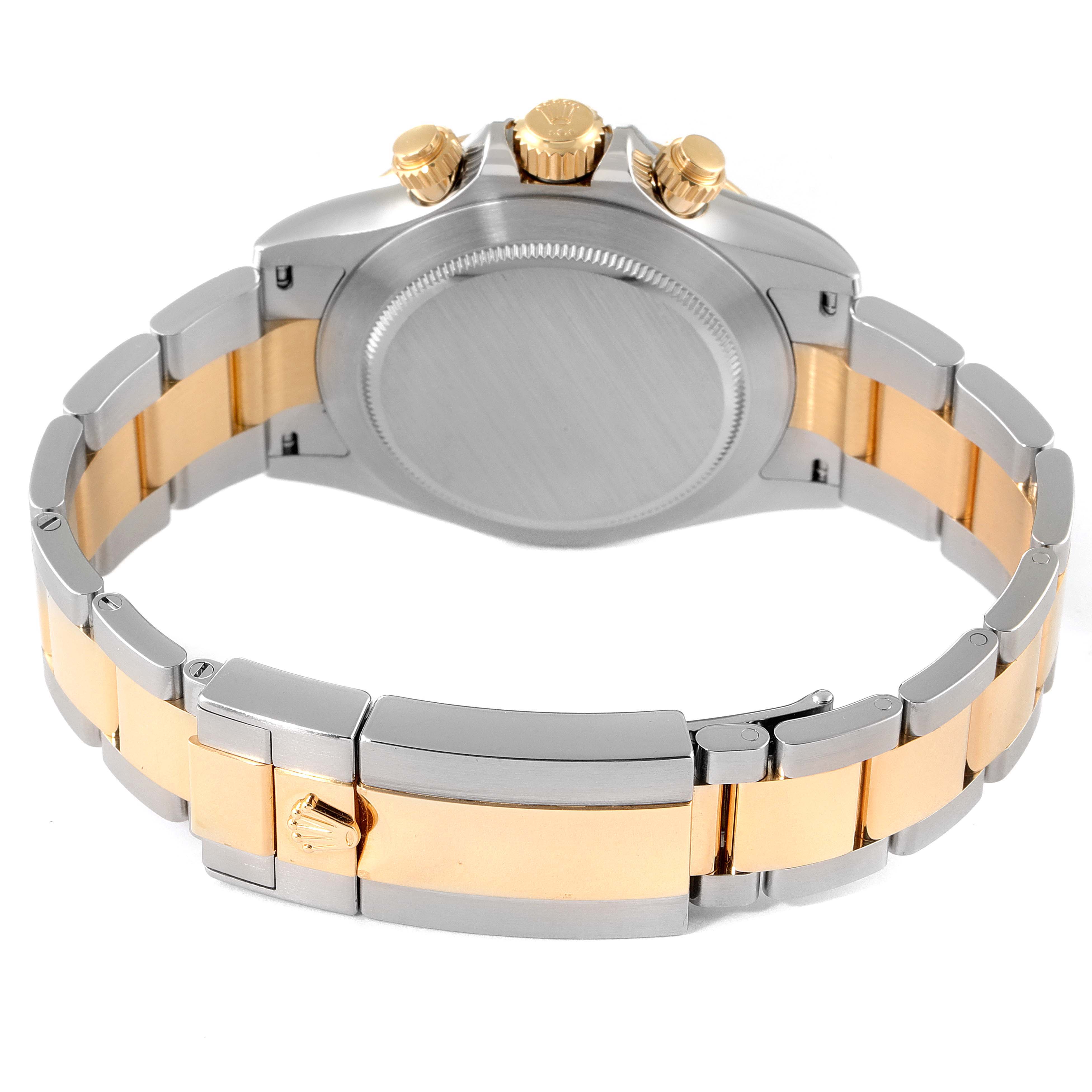 This image shows the case back, crown, pushers, and bracelet of a Rolex Daytona 116503 Men
s Steel and Gold (two tone) White Dial 116503 Men
s Steel and Gold (two tone) White Dial watch from a rear angle.