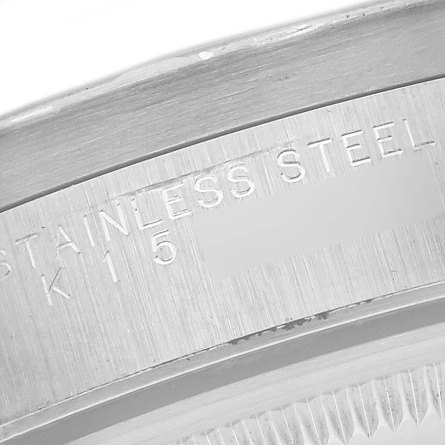 The image shows a close-up of the Rolex Date 15210 Men's Stainless Steel Blue Dial 15210 Men's Stainless Steel Blue Dial model's stainless steel case back with engraved text.