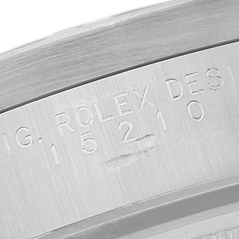 The image shows a close-up of the engraving on the Rolex Date 15210 Men's Stainless Steel Blue Dial 15210 Men's Stainless Steel Blue Dial model, focusing on the serial and reference numbers.