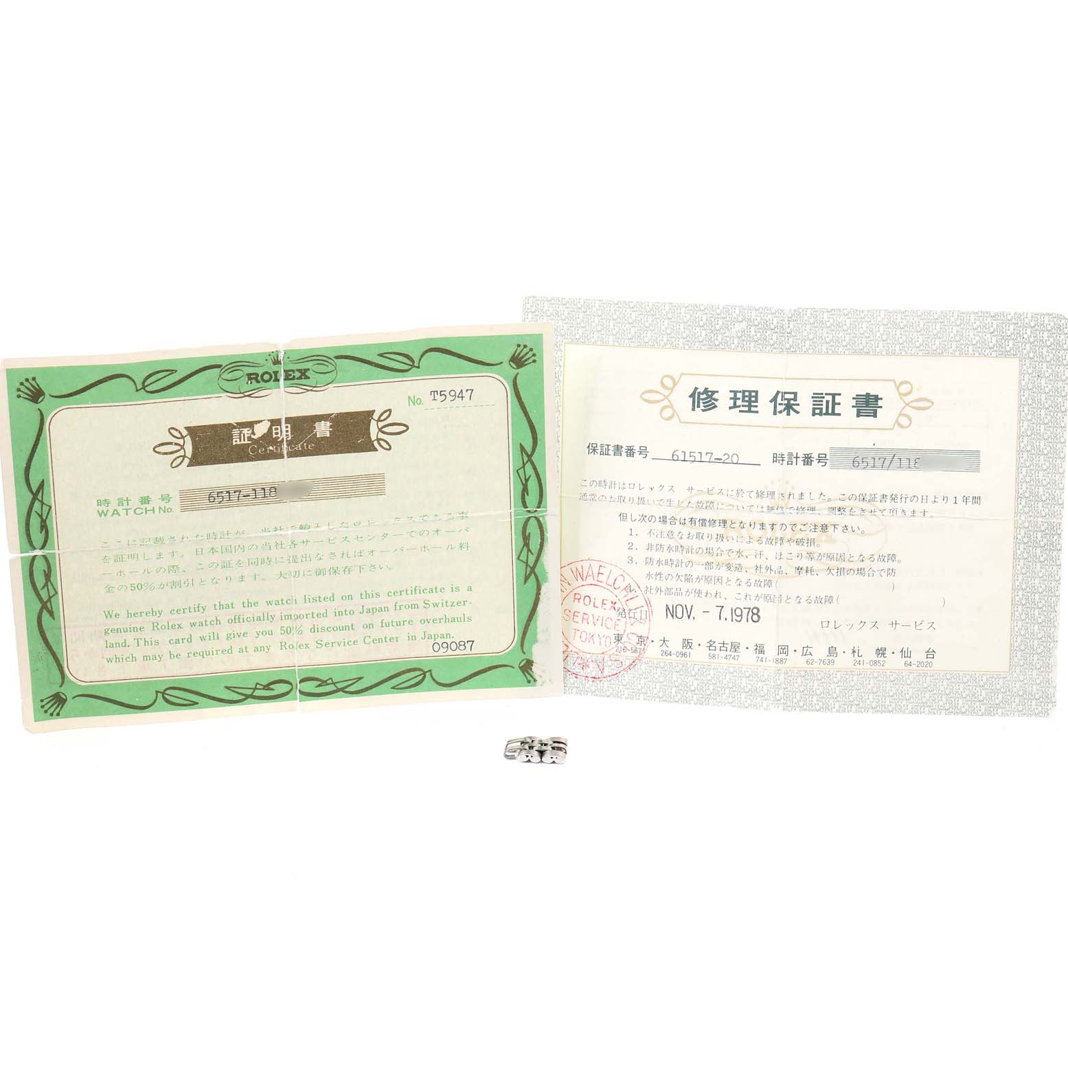 This image shows the paperwork and a metal link for a Rolex Date 6517 Women's Stainless Steel Silver Dial 6517 Women's Stainless Steel Silver Dial model watch.