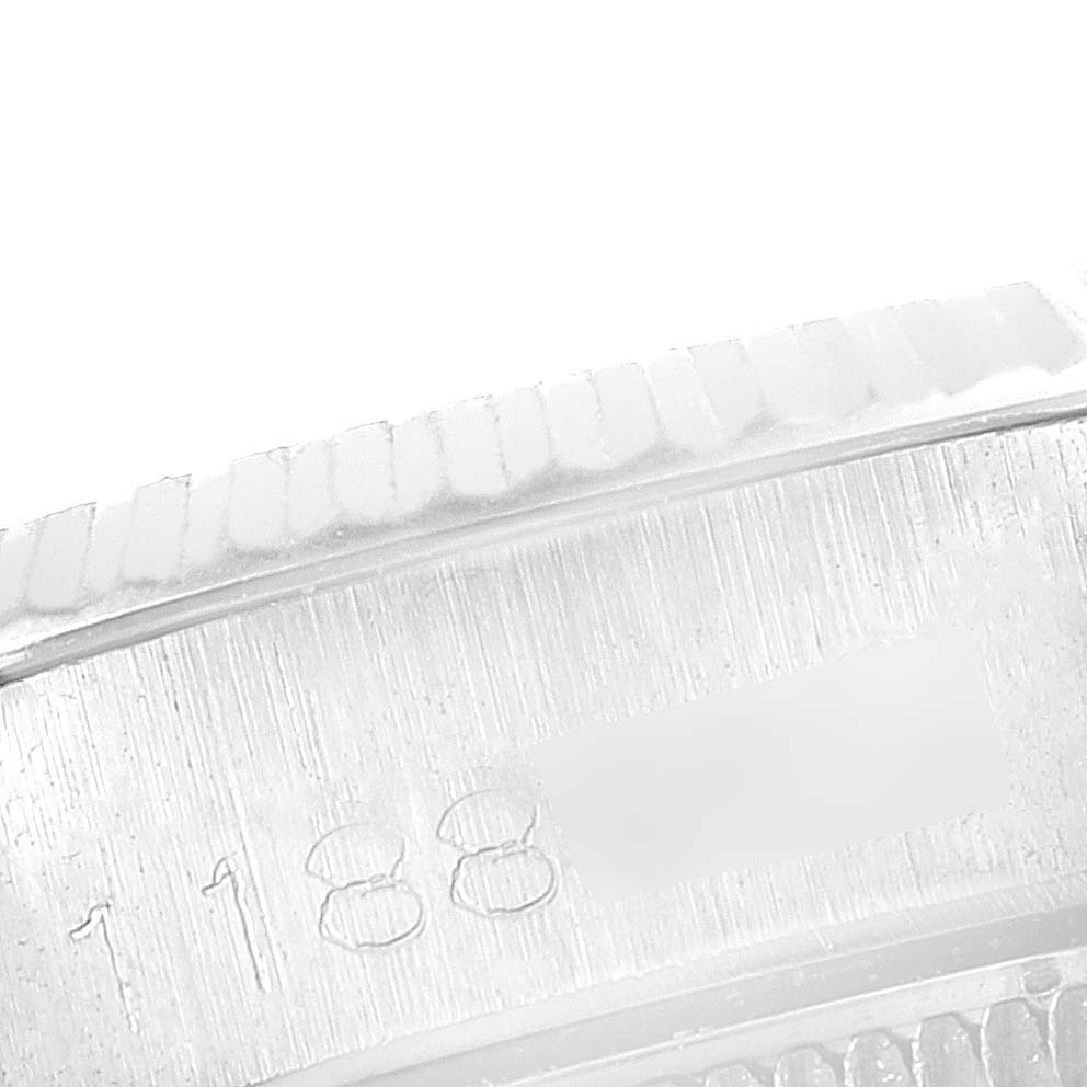 Close-up of the engraved bezel and the textured case edge of a Rolex Date 6517 Women's Stainless Steel Silver Dial 6517 Women's Stainless Steel Silver Dial model watch.