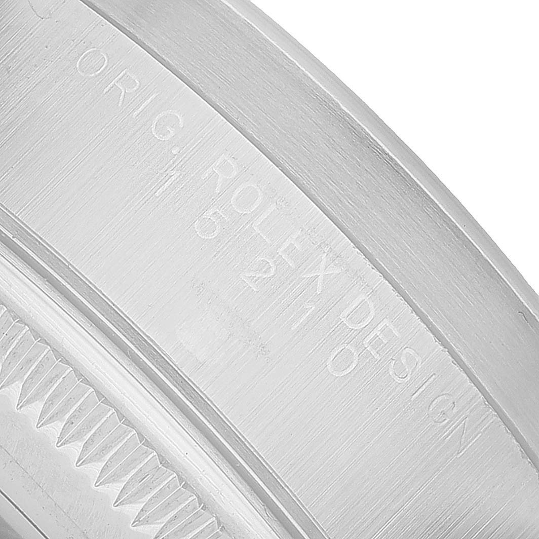 The image shows a close-up side angle of a Rolex Date 15210 Men's Stainless Steel Silver Dial model, highlighting the engraved text on the watch case.